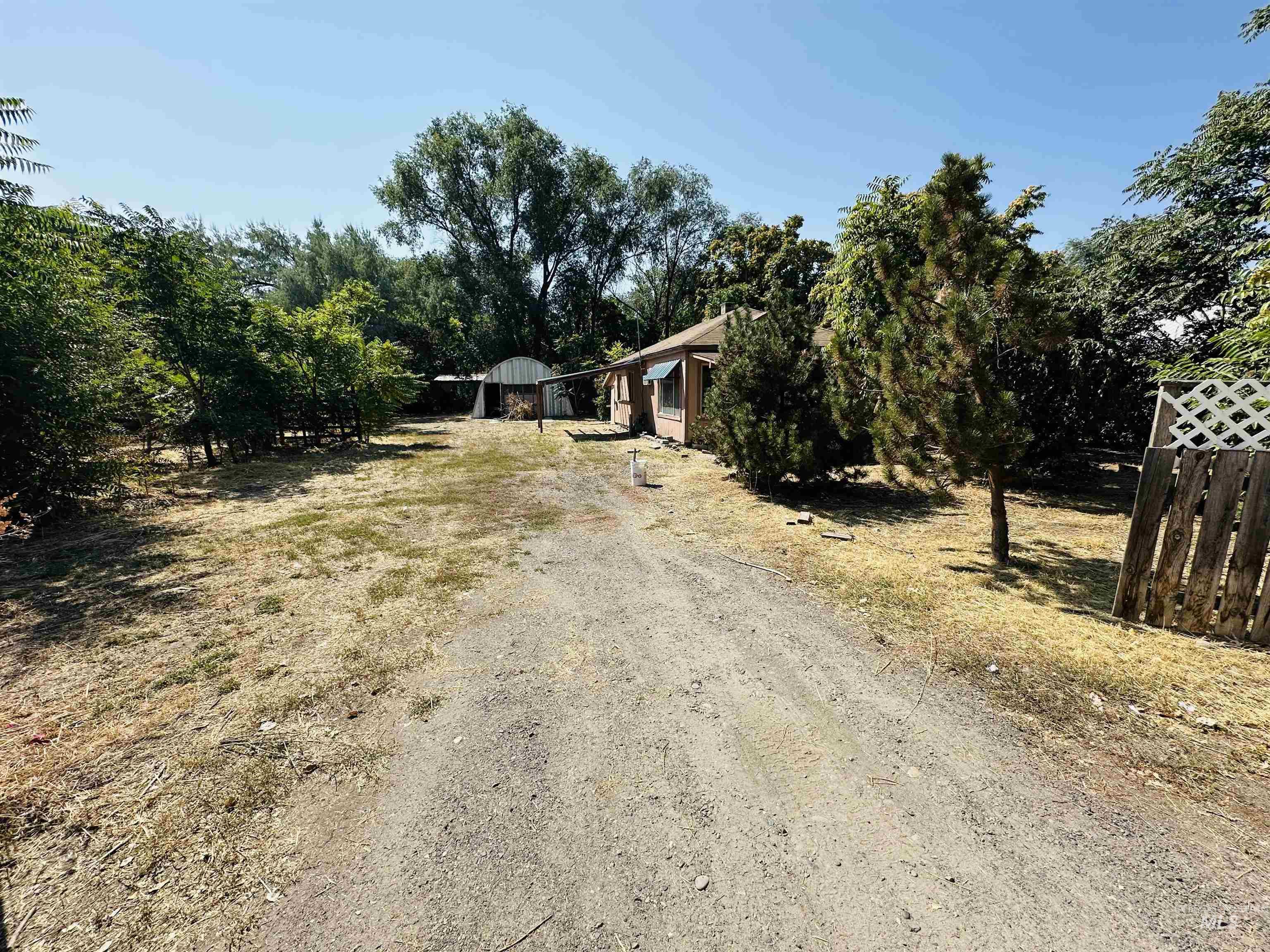 View of front of house with driveway and a carport