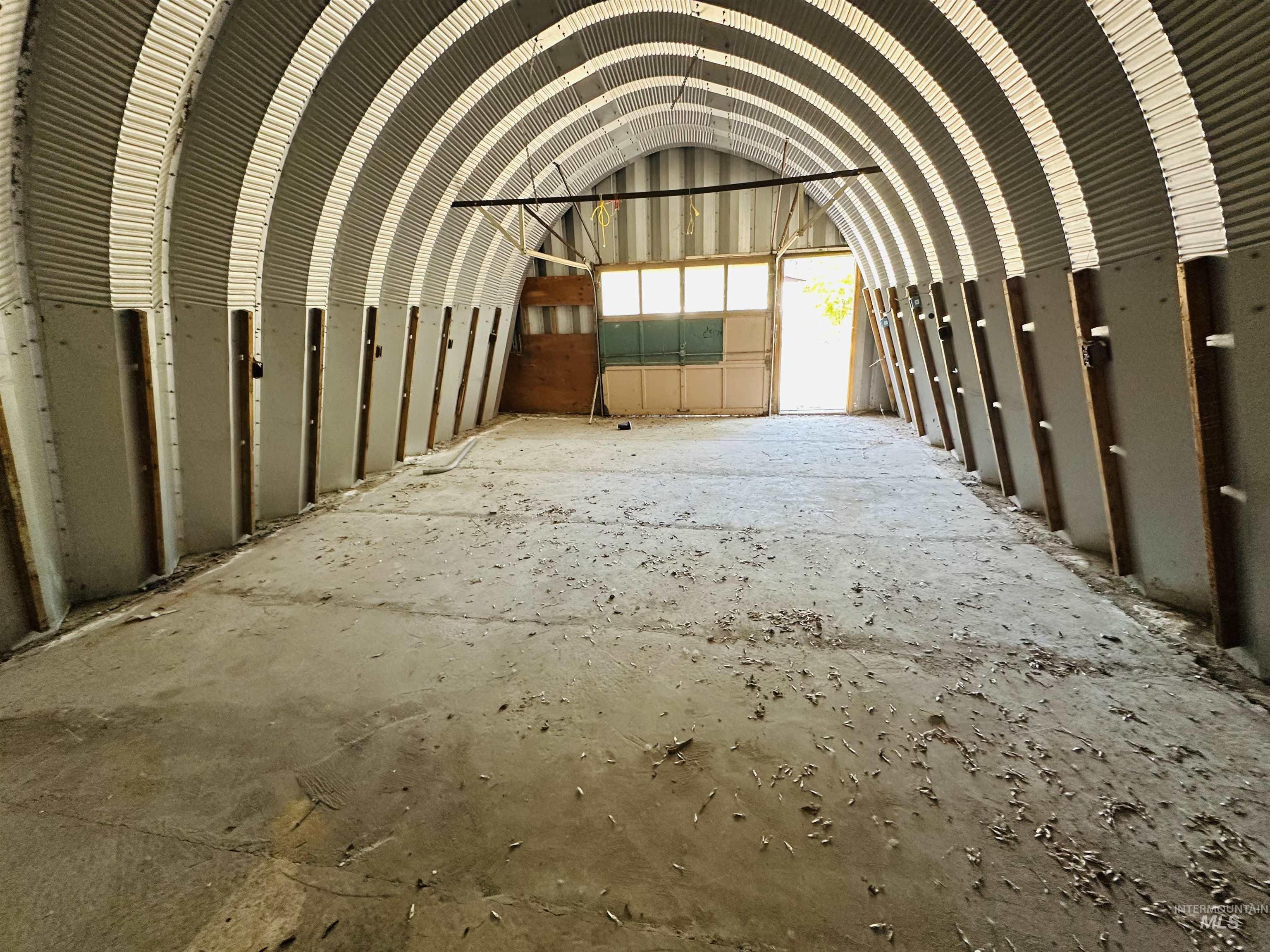 Misc room with metal wall, vaulted ceiling, and a garage