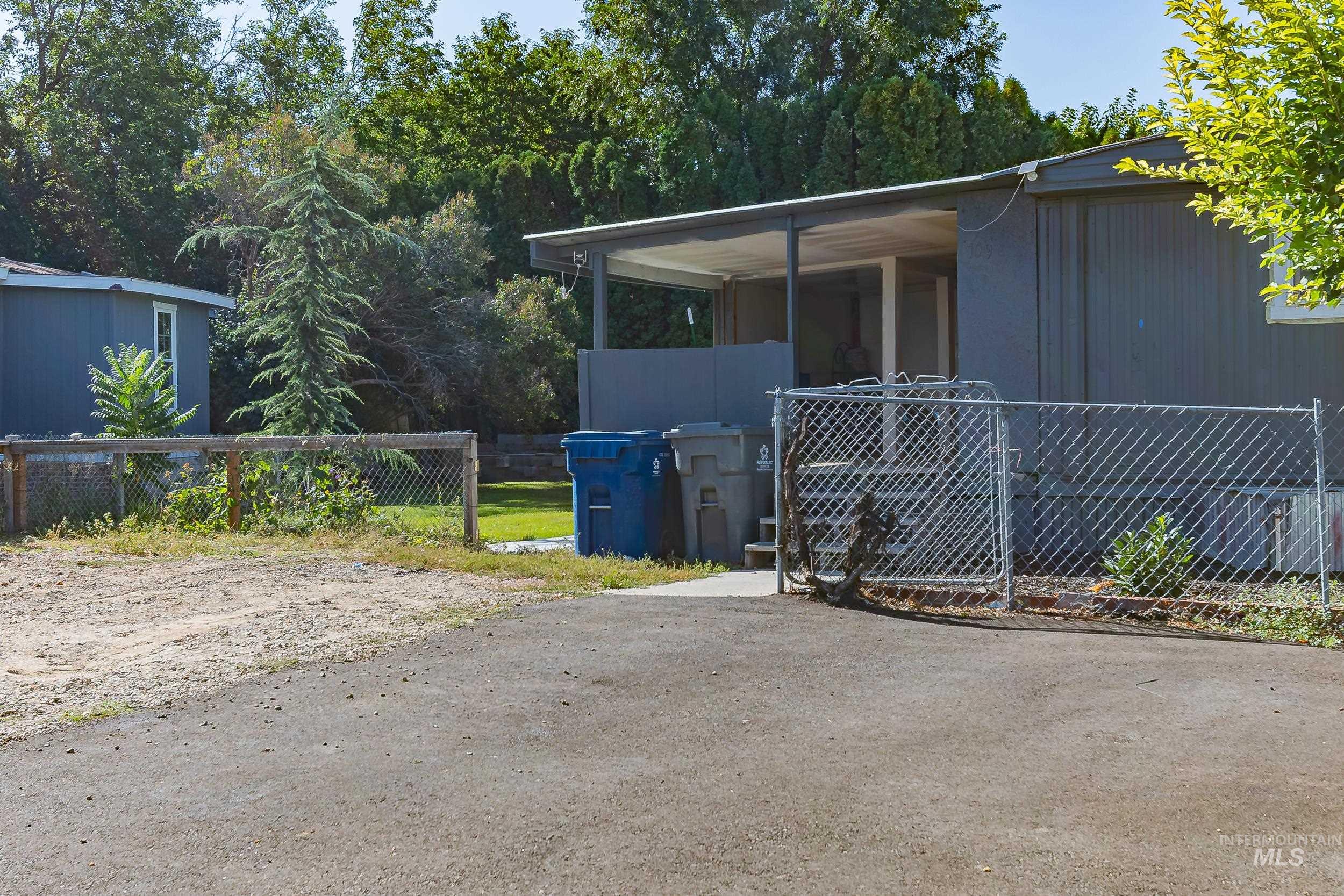 Gate featuring view of scattered trees