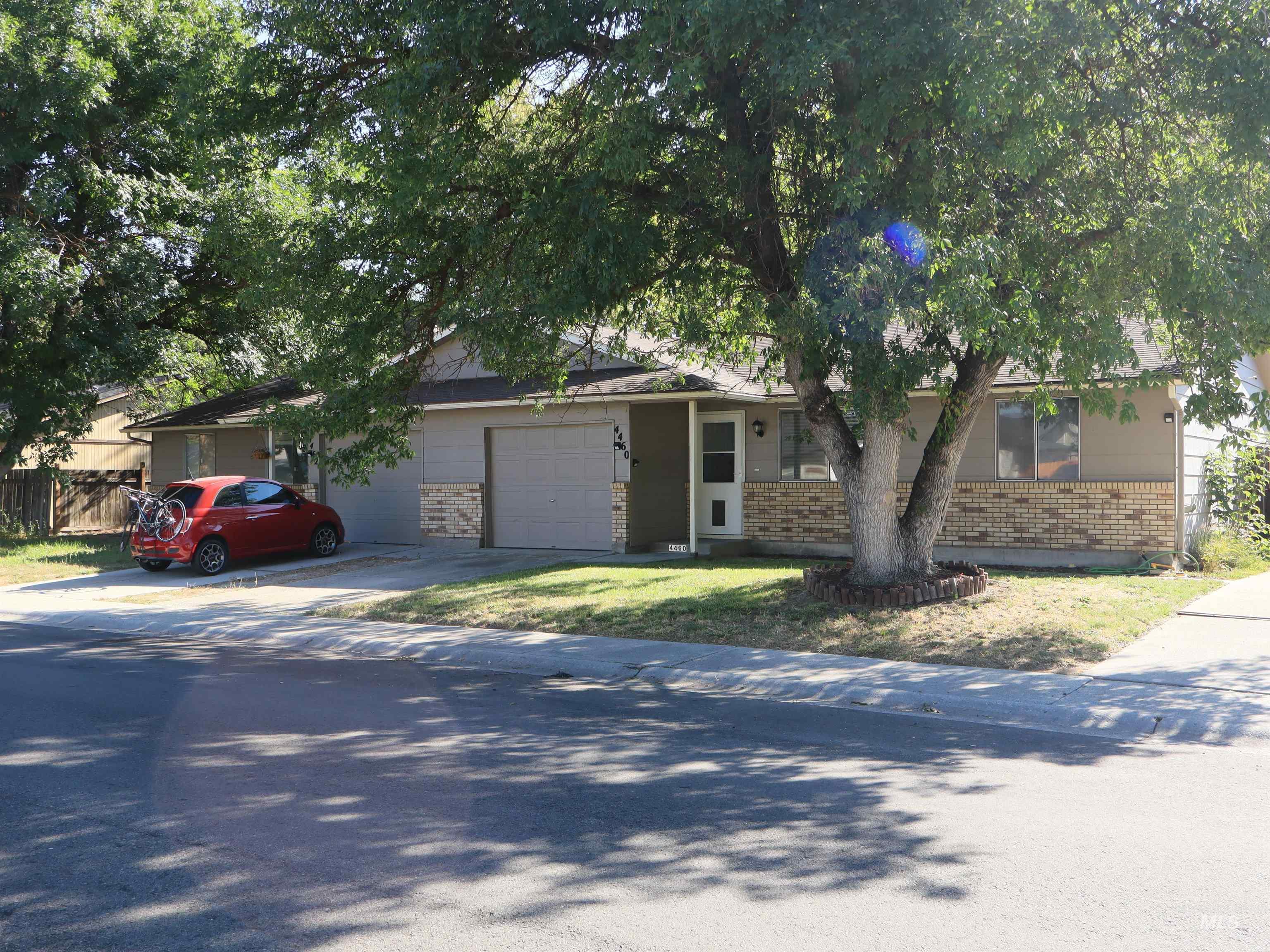 View of front facade featuring brick siding, a garage, and driveway