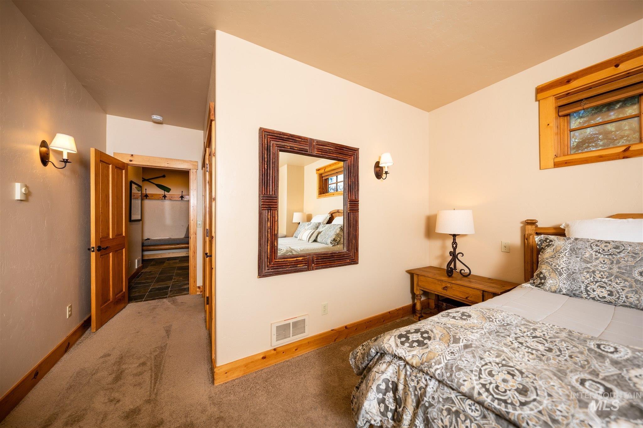 Bedroom featuring carpet floors and baseboards