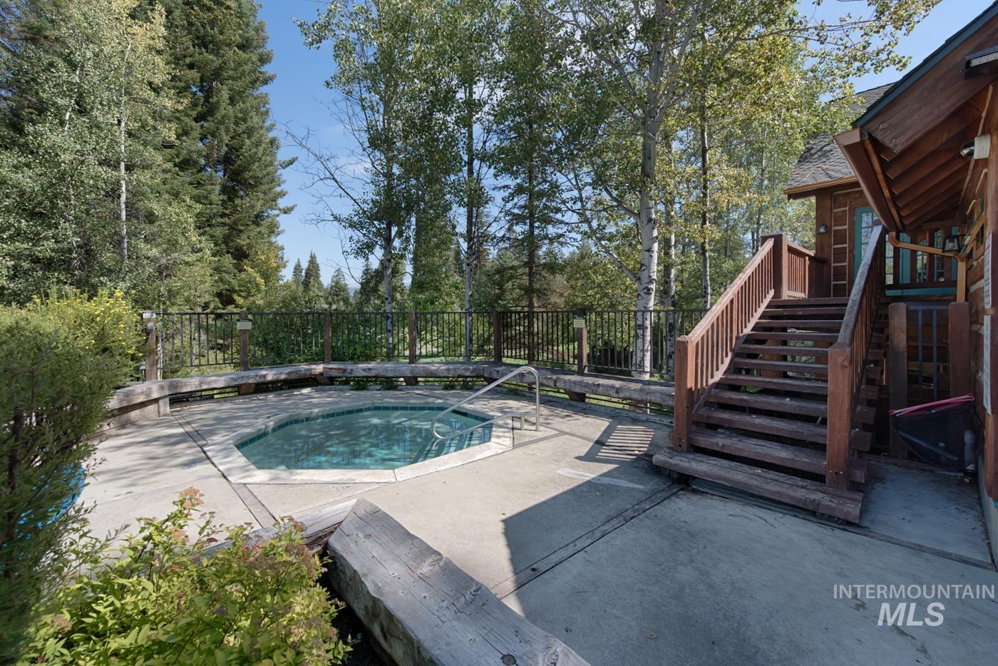View of pool featuring a patio, stairs, a wooden deck, and a pool