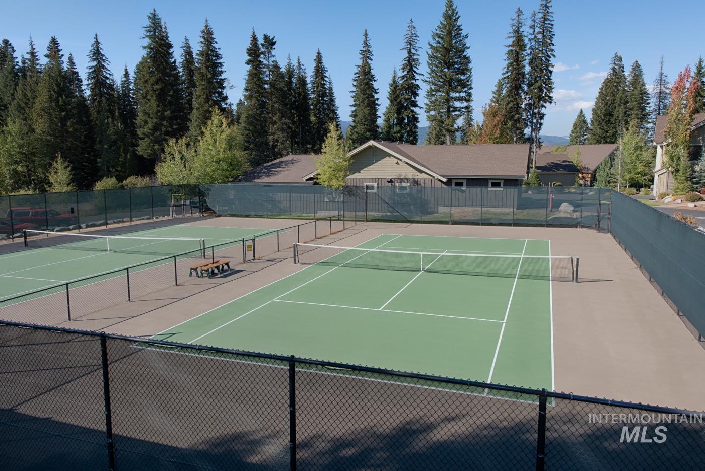 View of tennis court featuring community basketball court