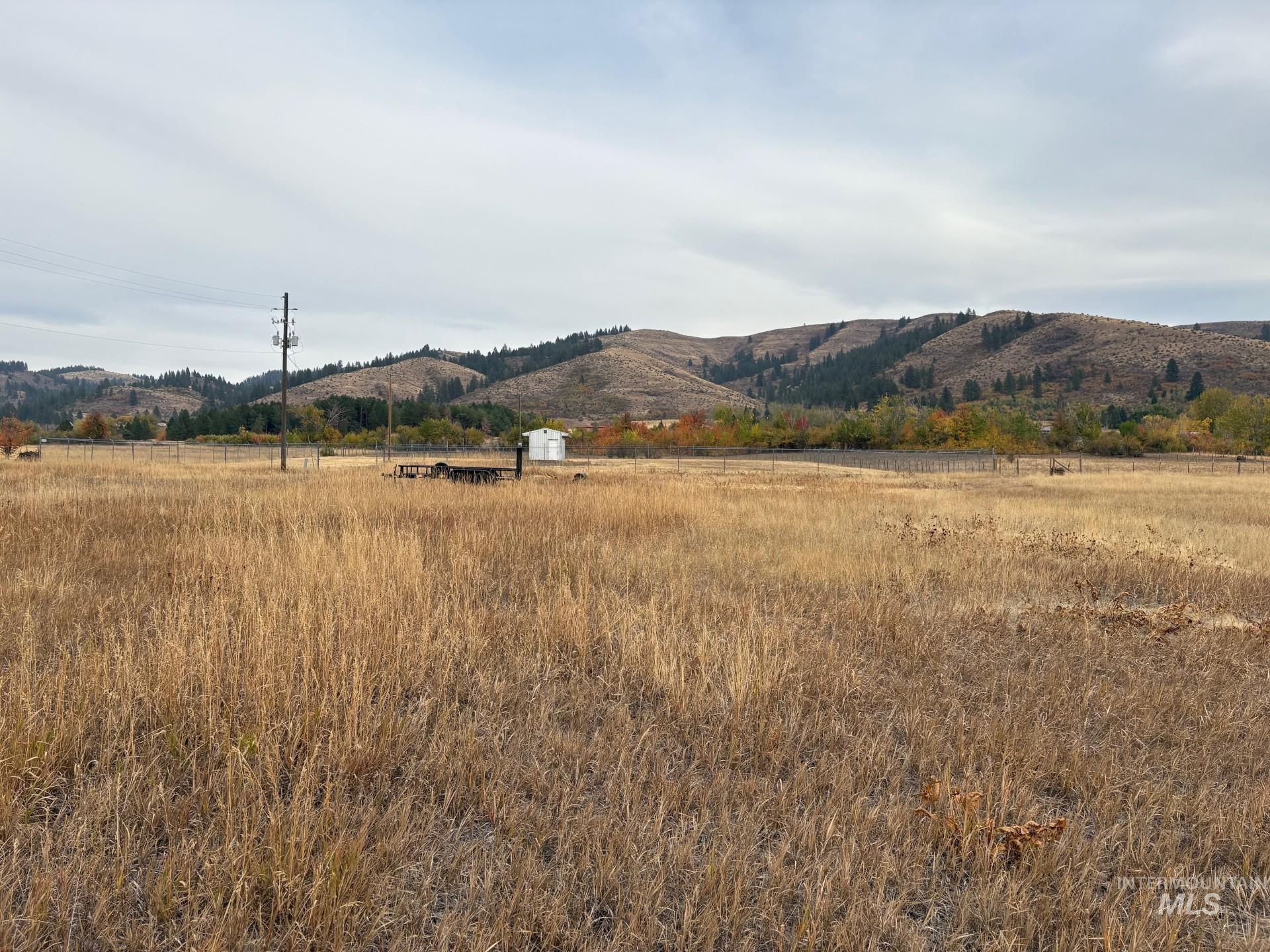 View of mountain backdrop featuring rural landscape