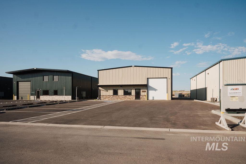 View of outbuilding featuring uncovered parking