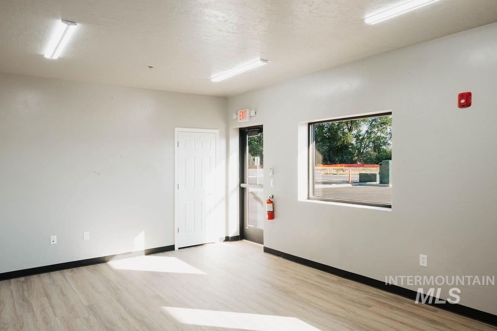 Spare room with wood finished floors and healthy amount of natural light