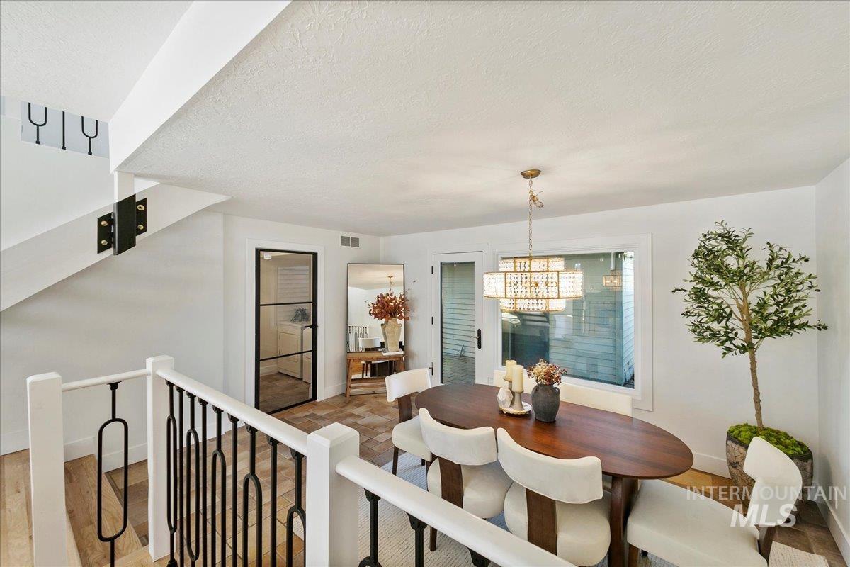 Dining area featuring a textured ceiling and a chandelier