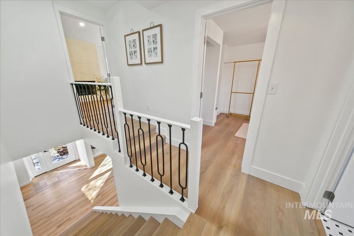 Stairway featuring wood finished floors and baseboards