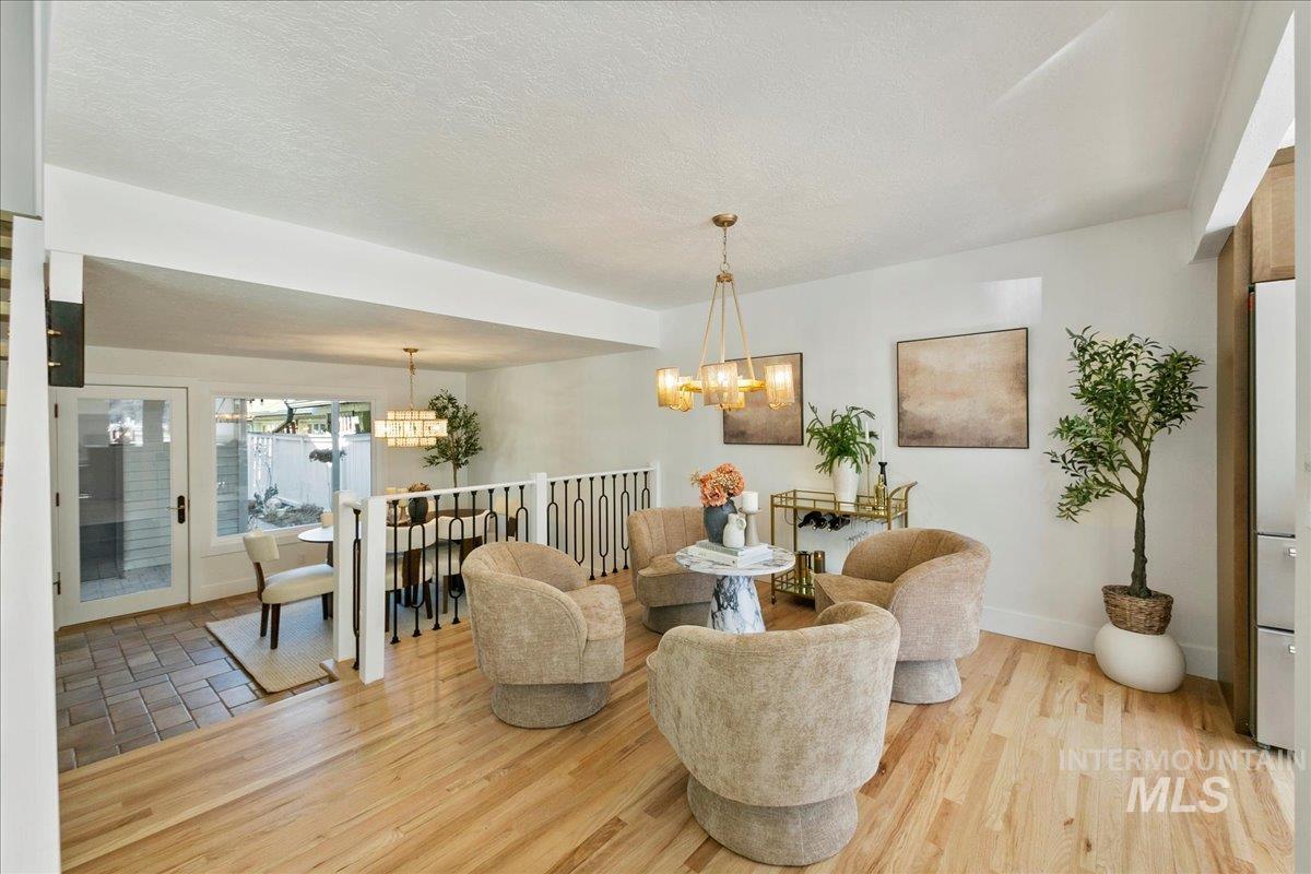 Dining area with light wood-style floors and a textured ceiling