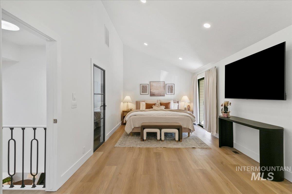 Bedroom featuring lofted ceiling, light wood-type flooring, and recessed lighting