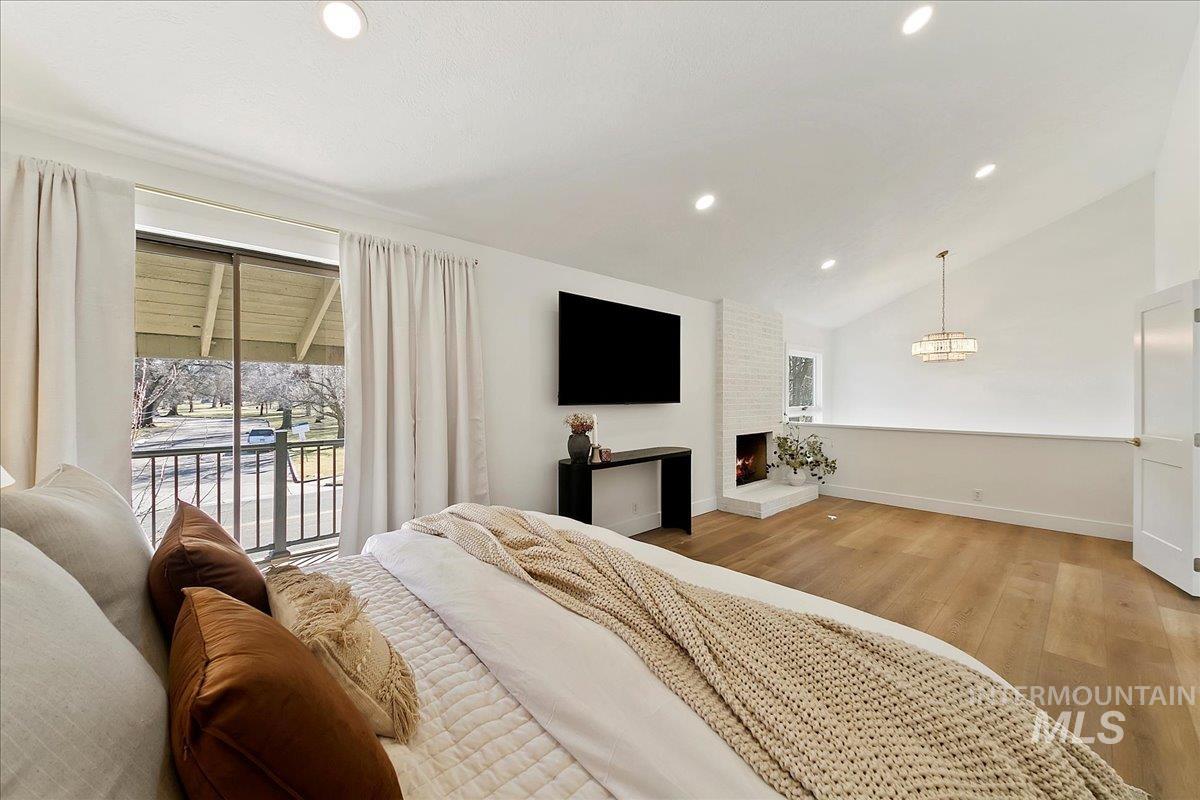Bedroom featuring lofted ceiling, multiple windows, light wood-style flooring, access to outside, and recessed lighting