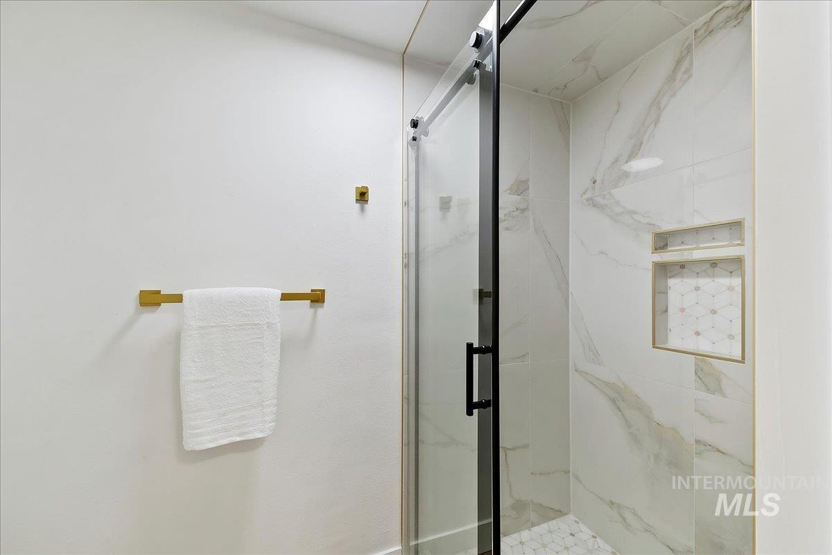 Full bathroom featuring a marble finish shower
