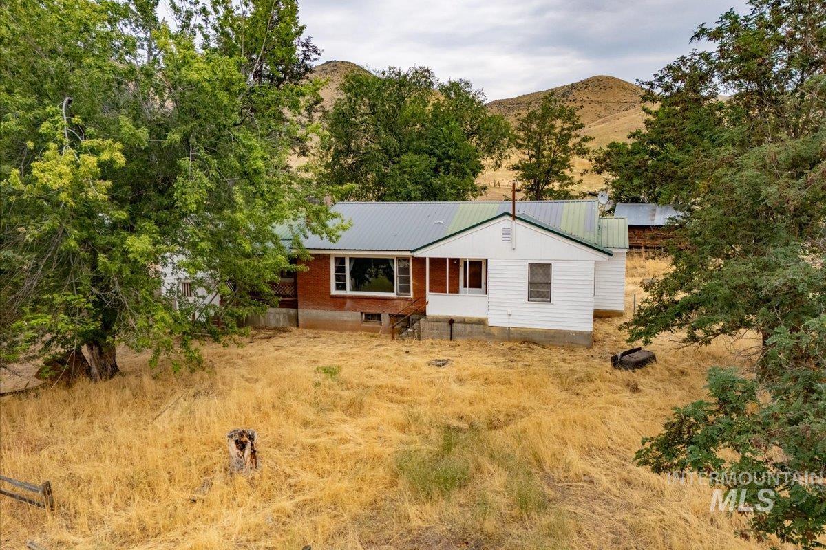 View of front of house featuring a mountain view and a metal roof