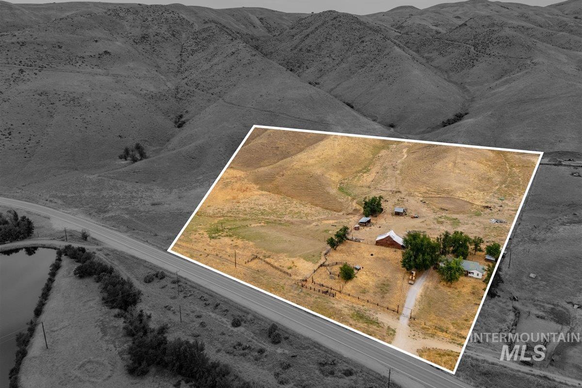 Aerial view of sparsely populated area featuring property parcel outlined