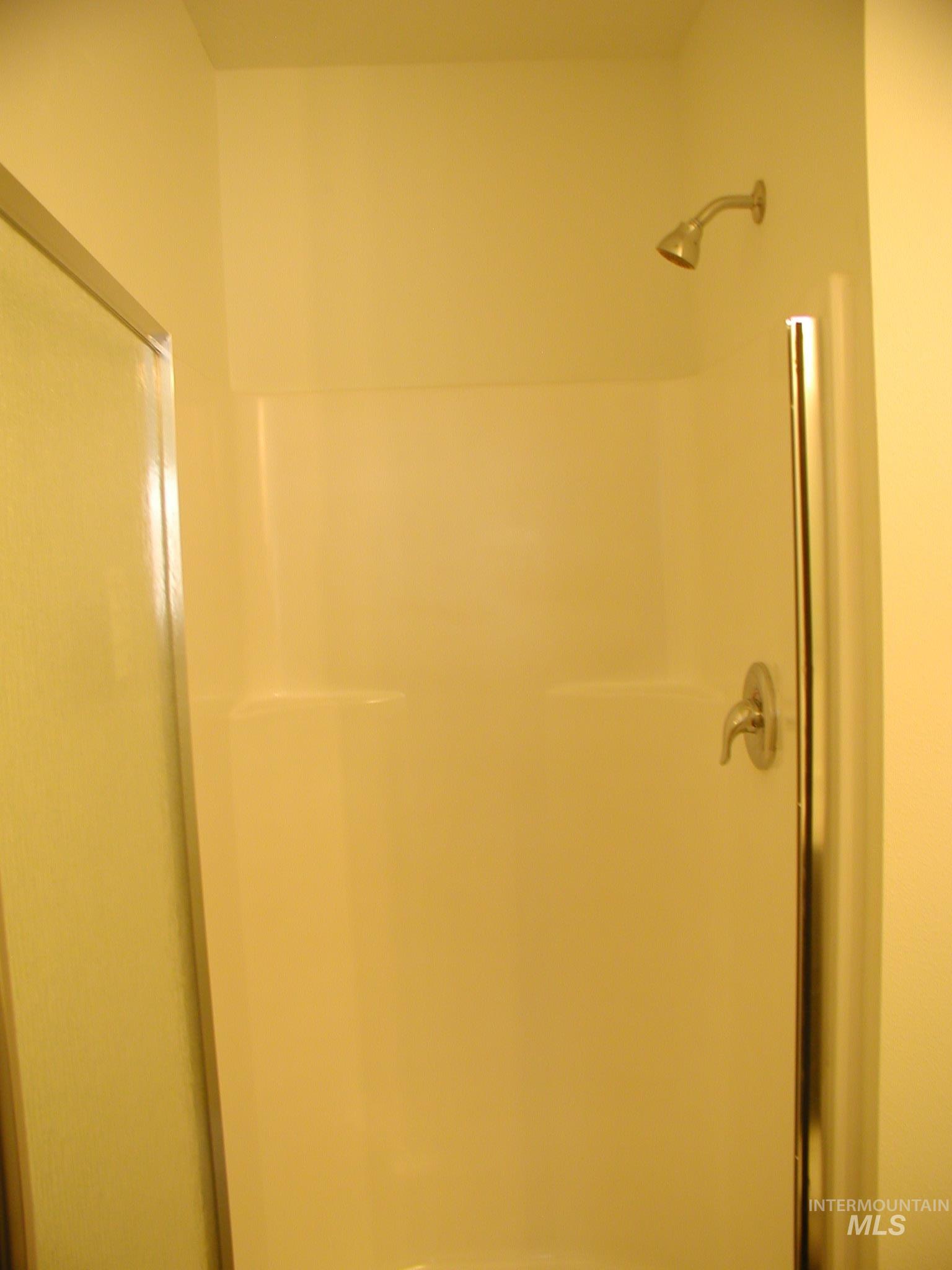 Full bathroom featuring a shower with shower door