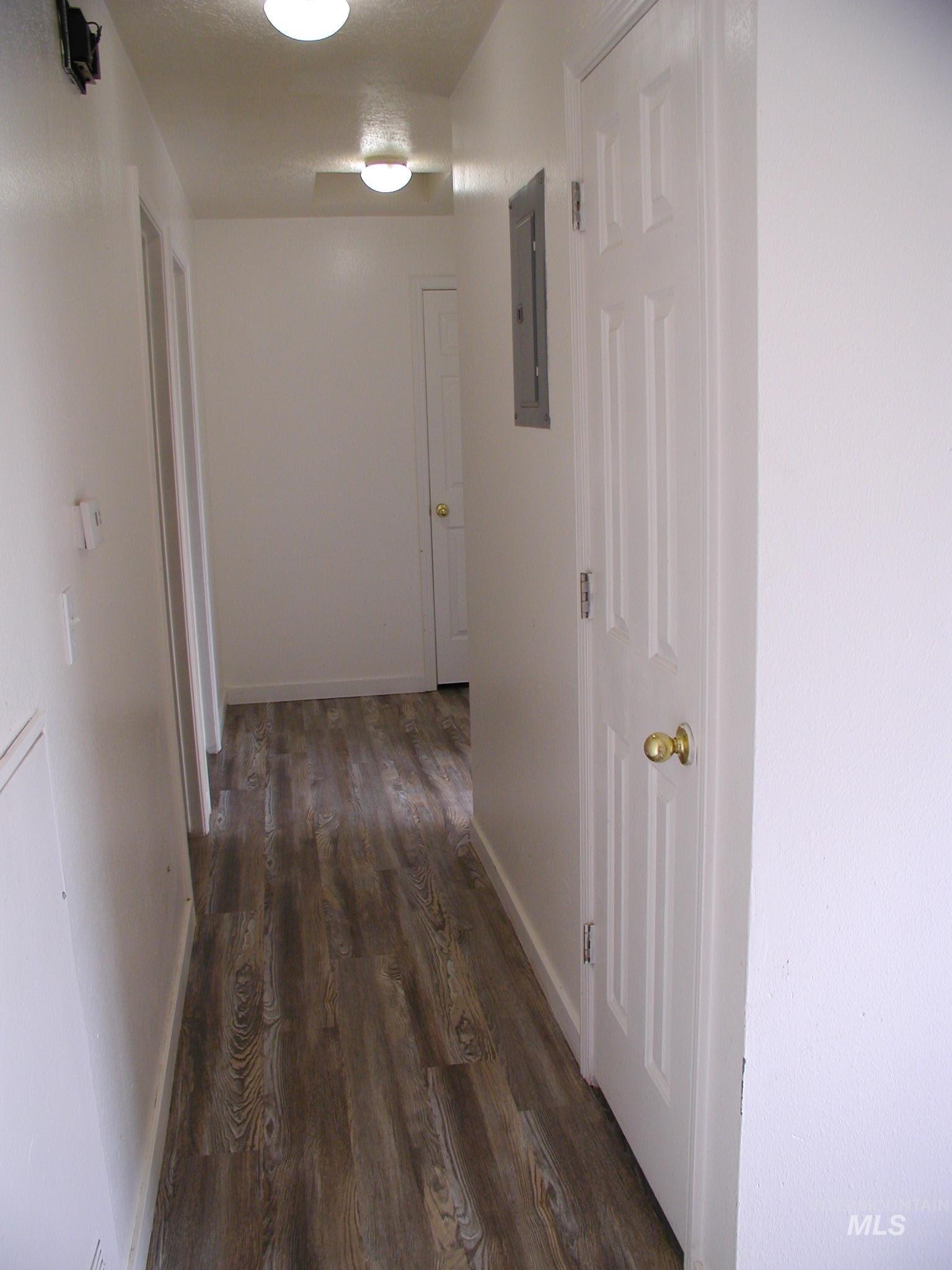 Hall featuring wooden walls