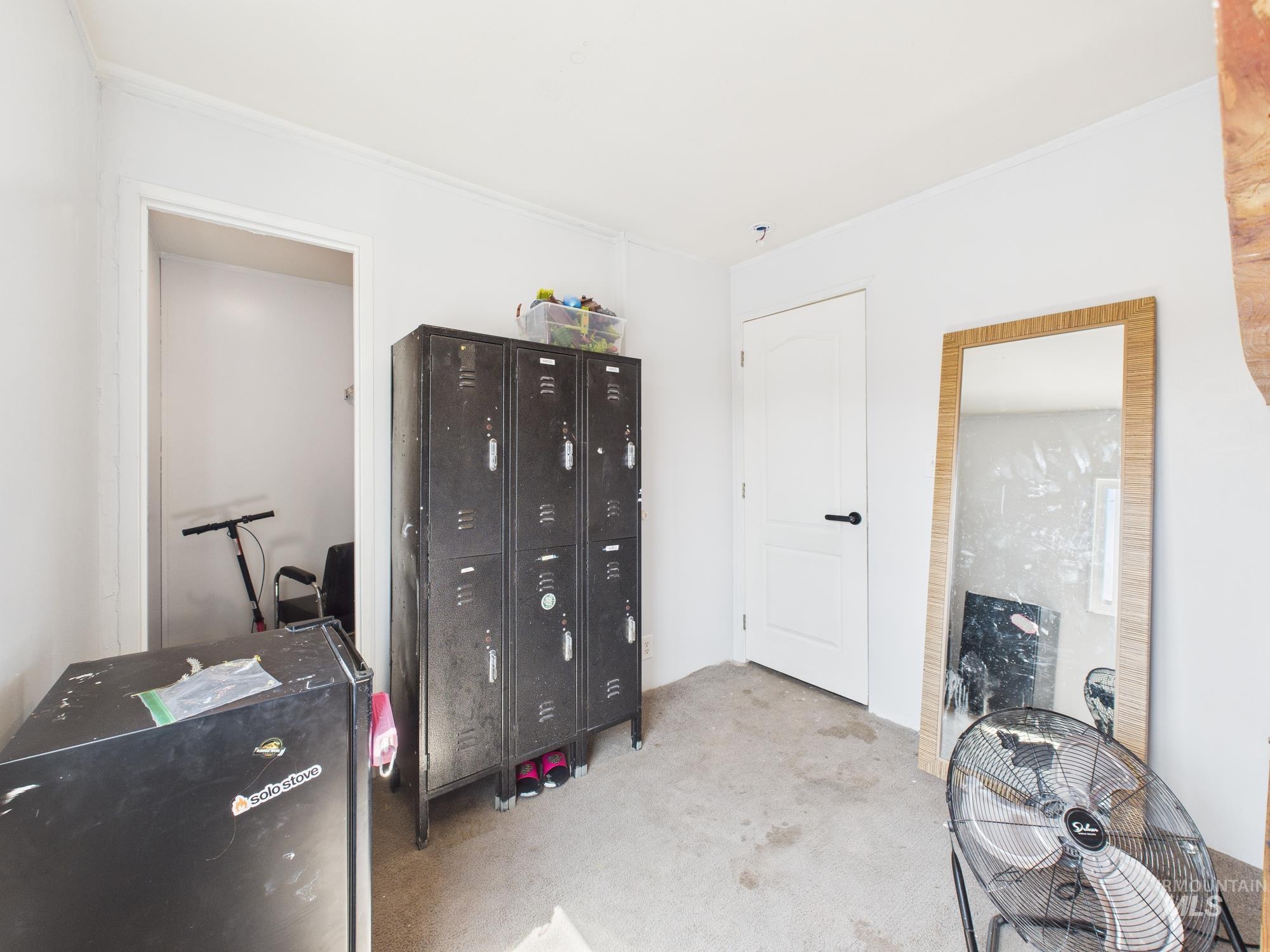 Bedroom with carpet flooring and an office area