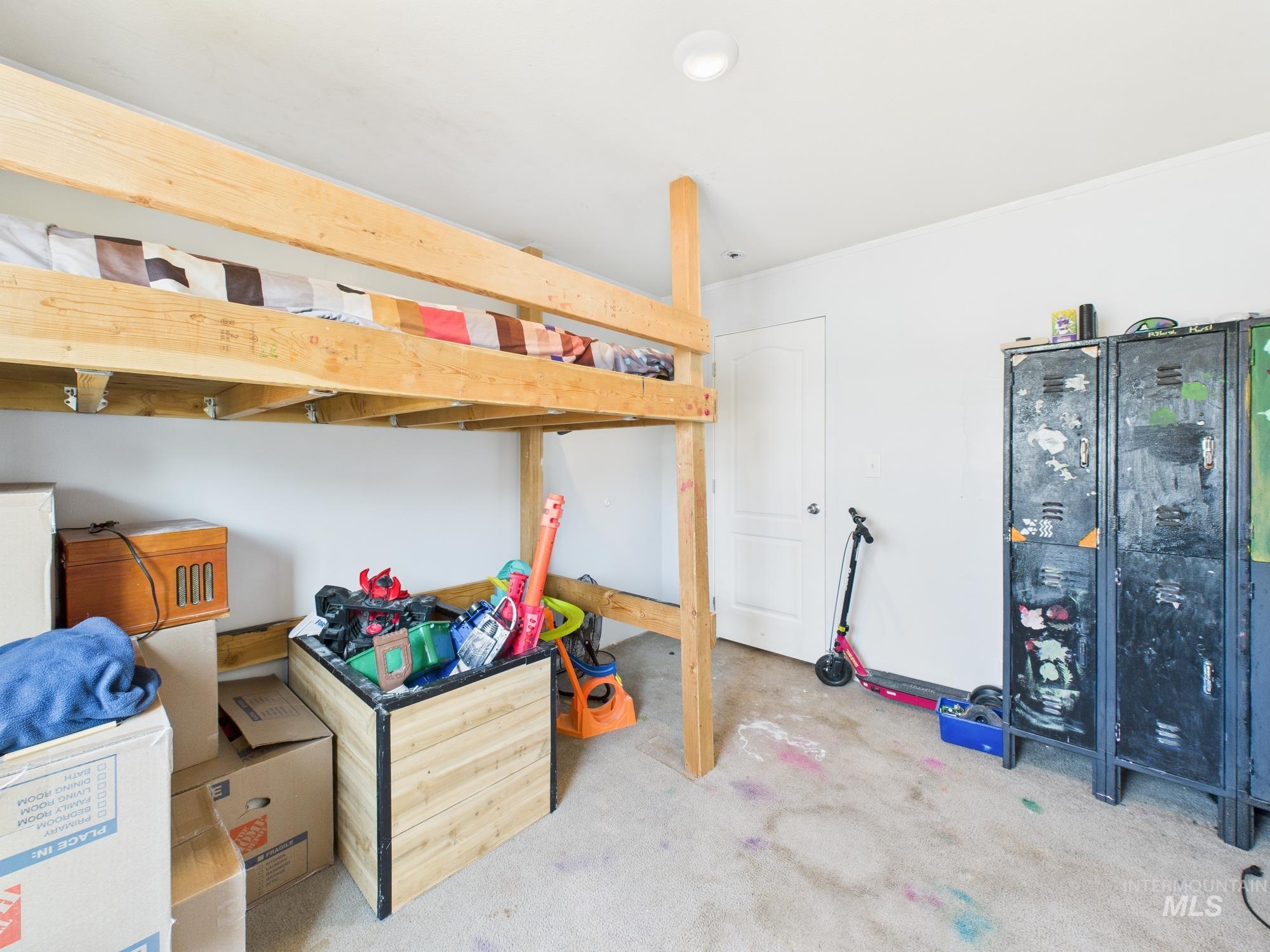 Bedroom featuring light carpet