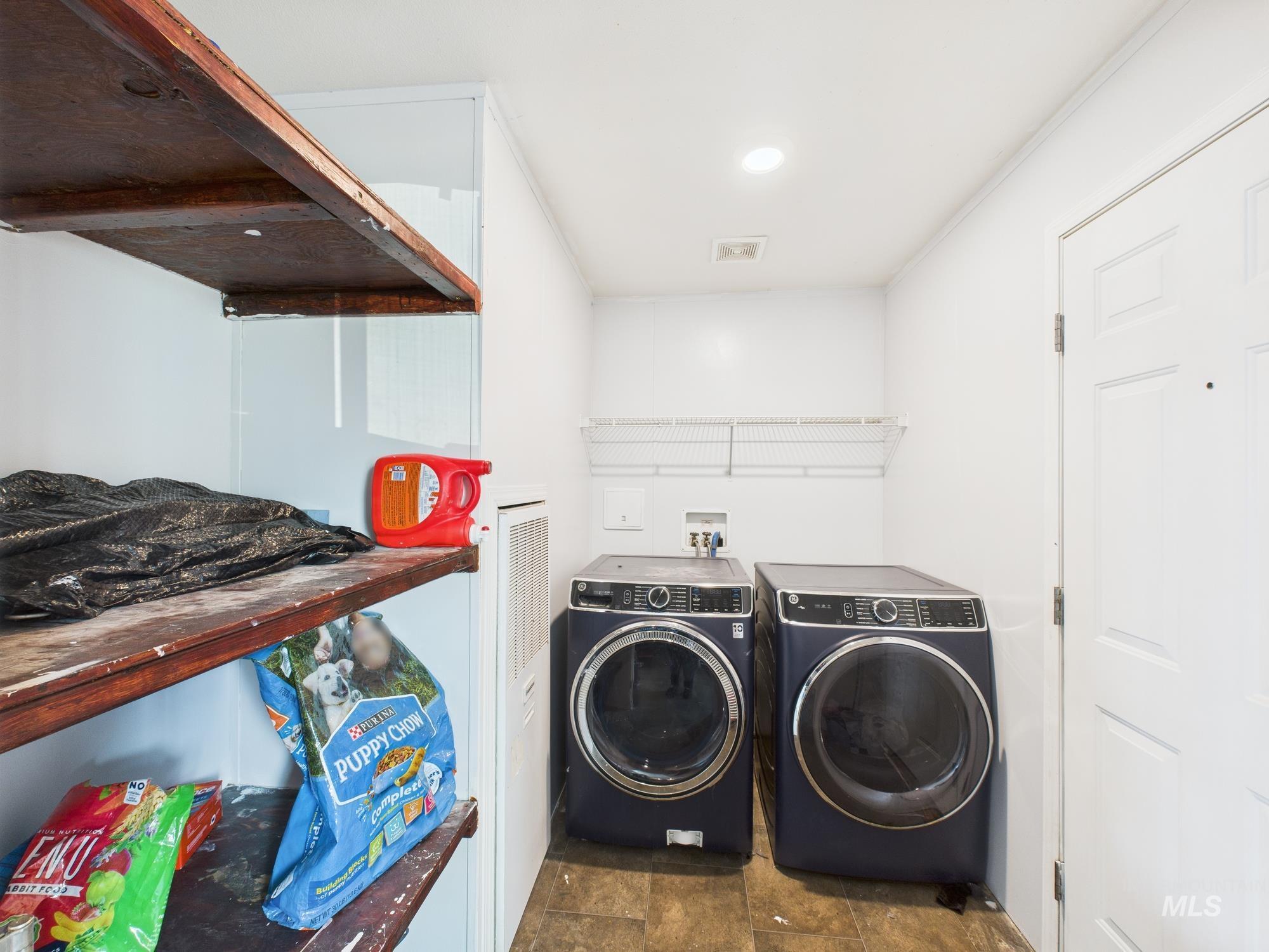Washroom with washer and clothes dryer