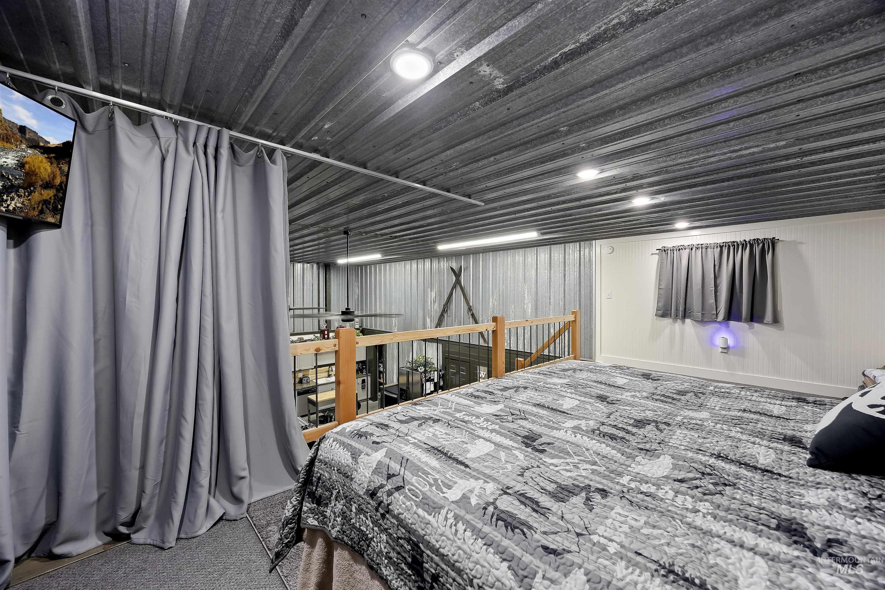 Bedroom featuring carpet flooring and baseboards