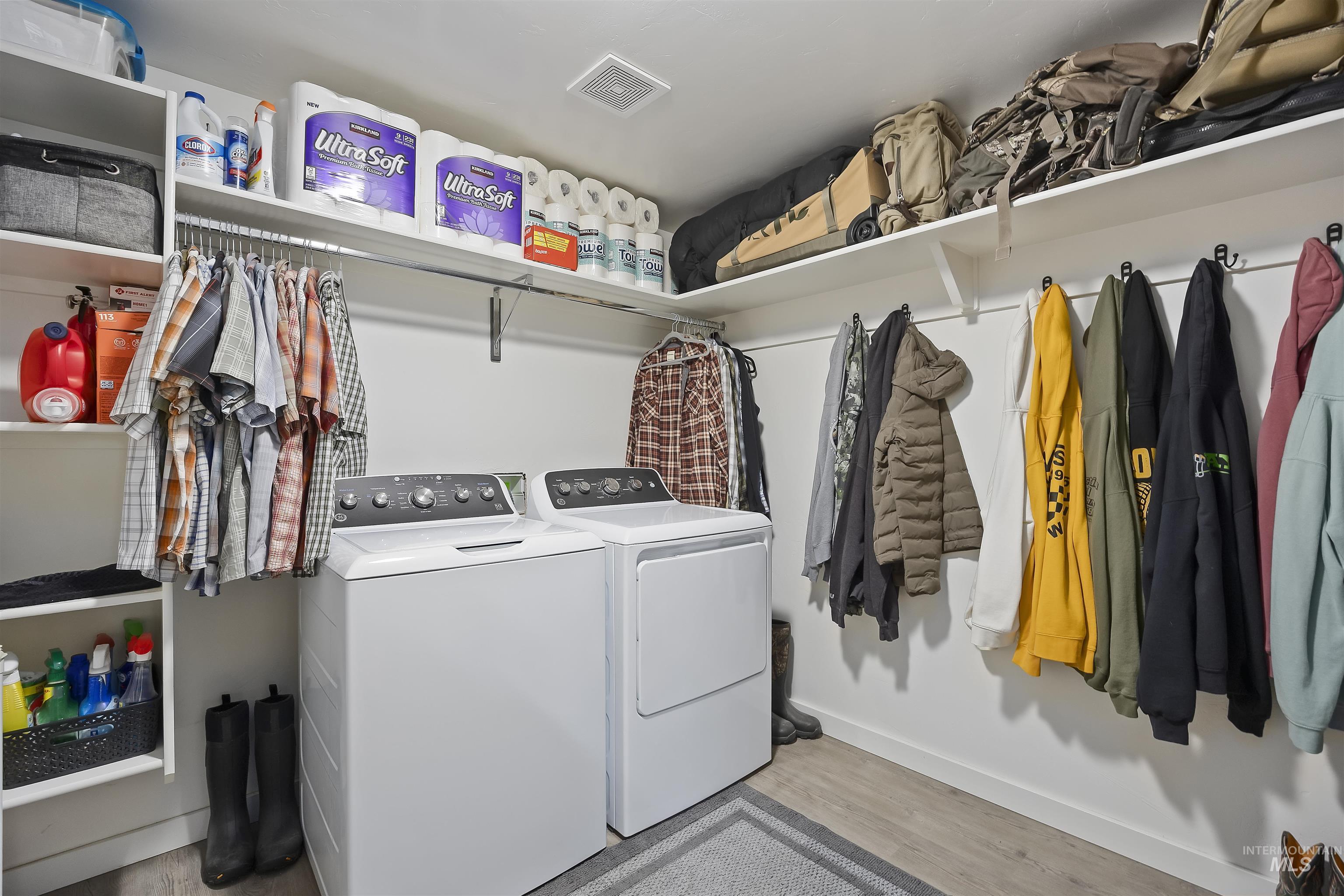 Washroom featuring light wood finished floors and separate washer and dryer