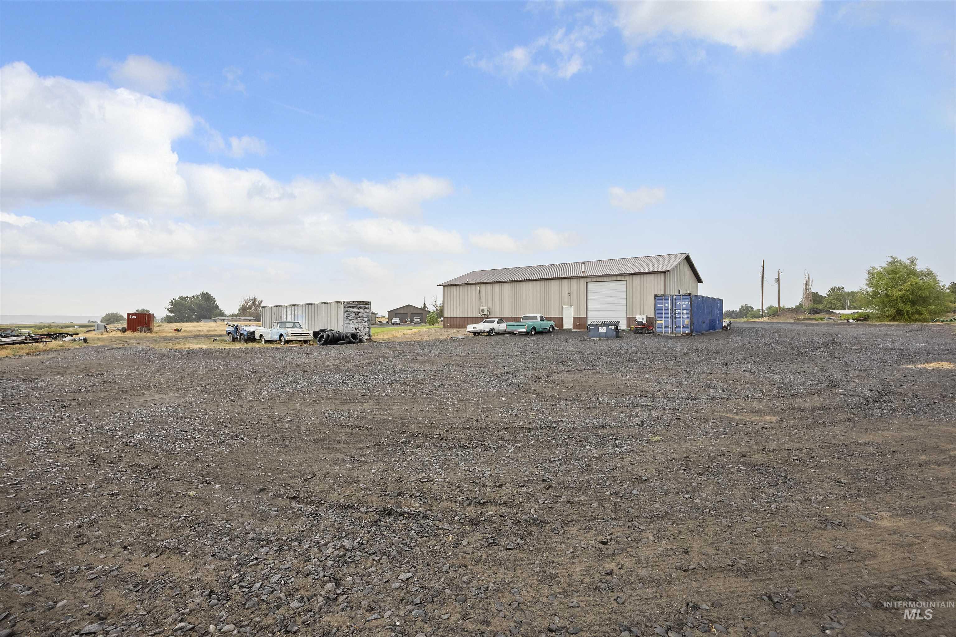 View of yard with a detached garage and an outbuilding