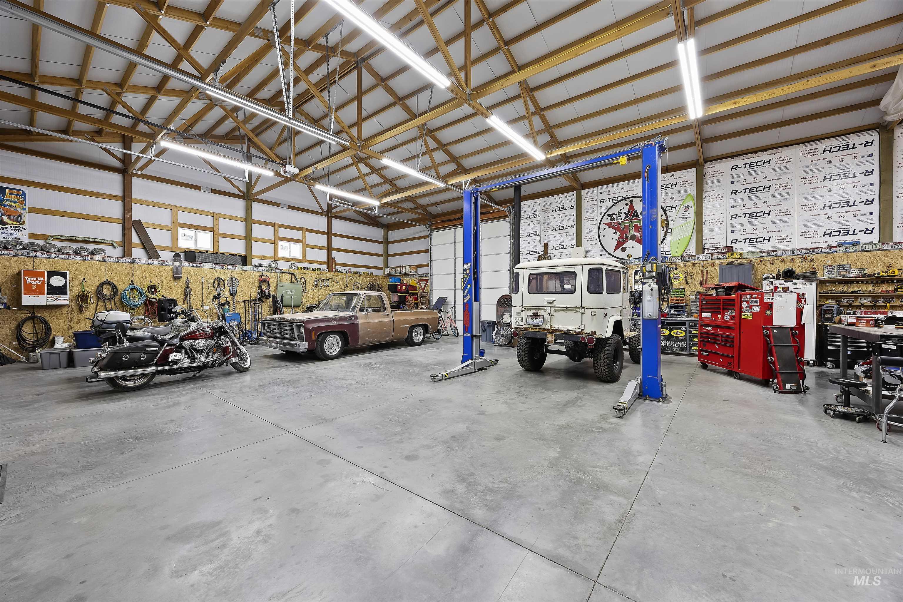 Garage featuring a workshop area and metal wall