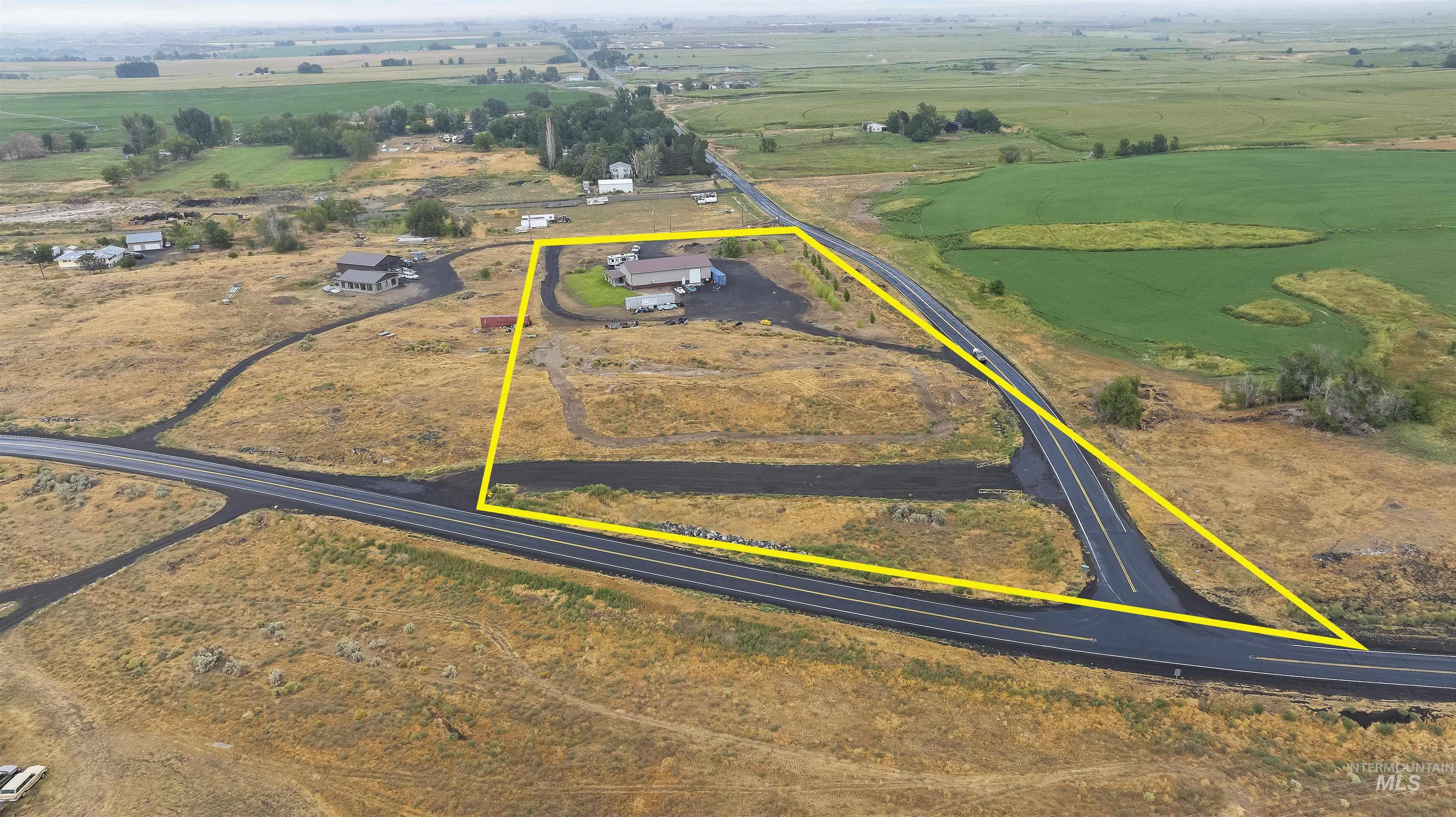 Aerial view of sparsely populated area featuring property parcel outlined