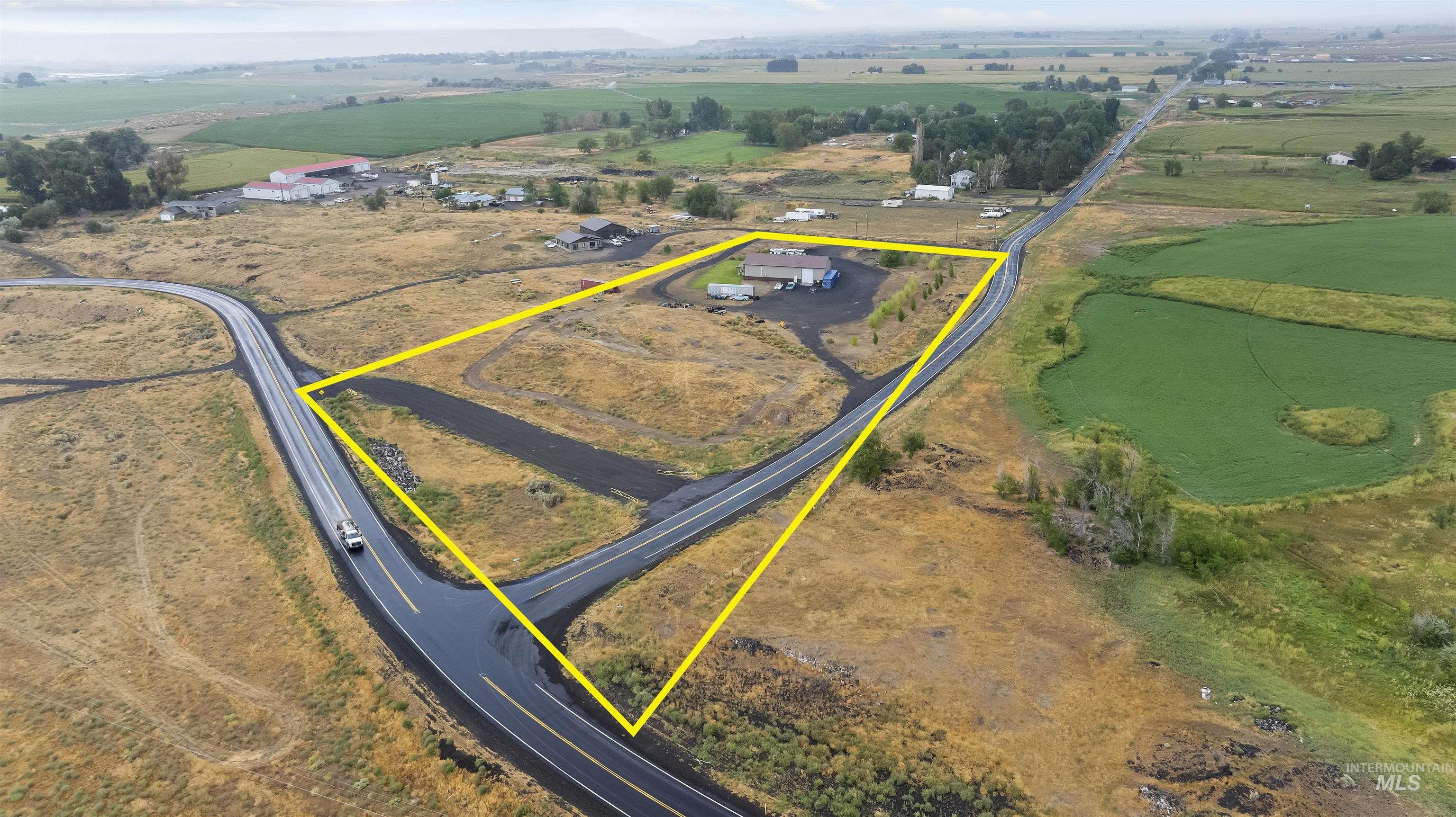 Aerial view of sparsely populated area featuring property parcel outlined