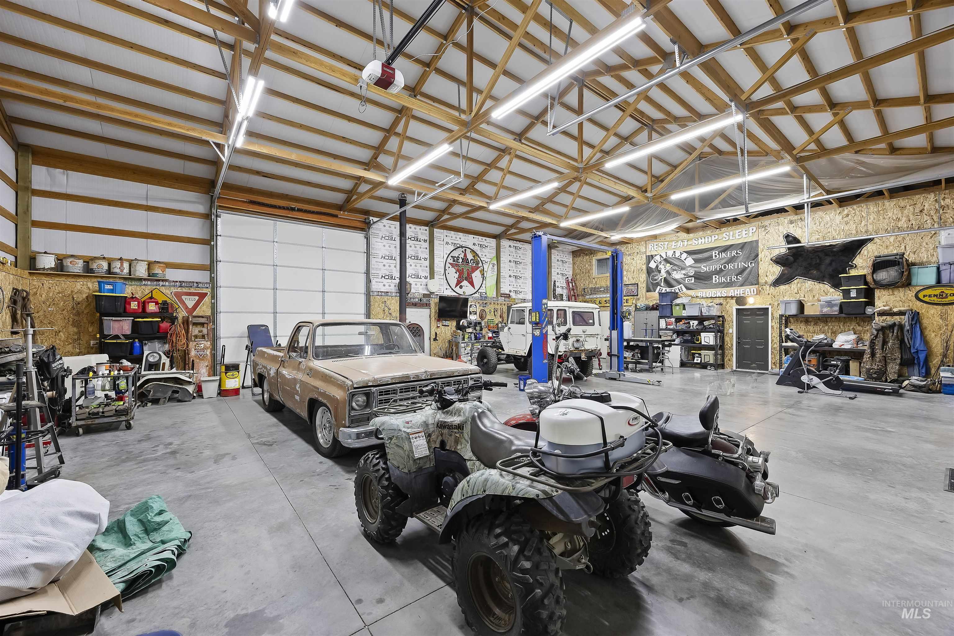 Garage featuring metal wall and a garage door opener