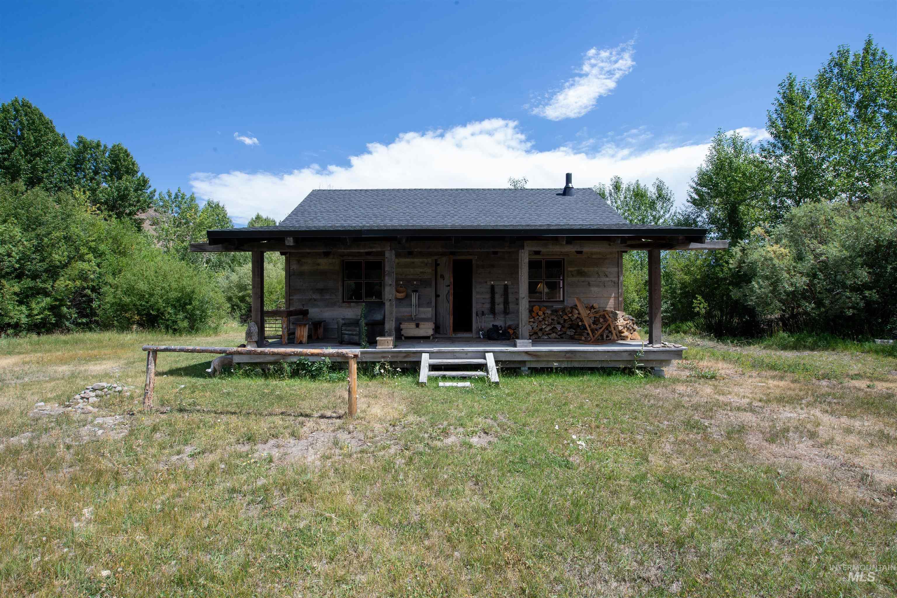 Back of property with a yard and covered porch