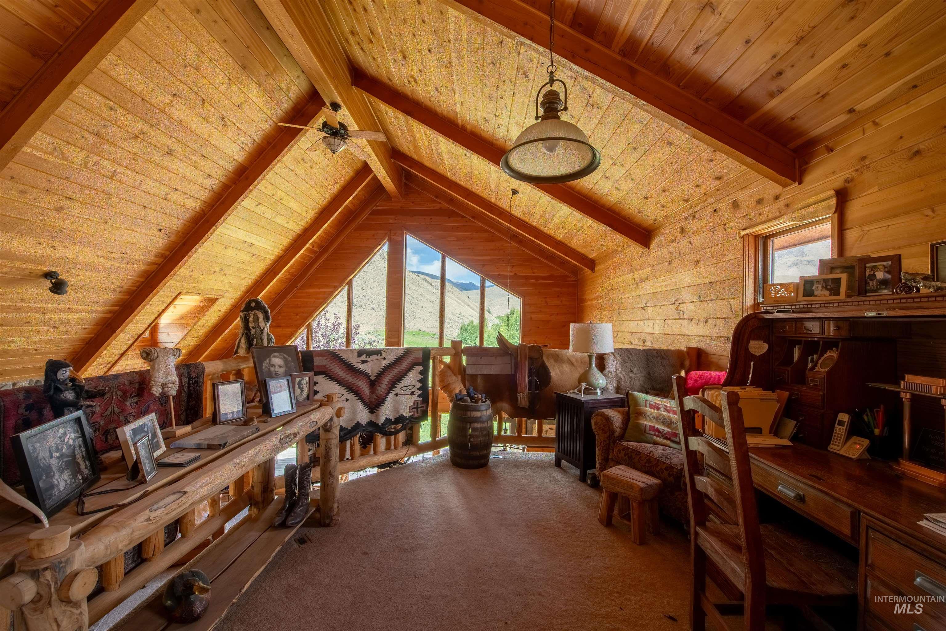 Home office featuring wooden ceiling, wood walls, and carpet floors