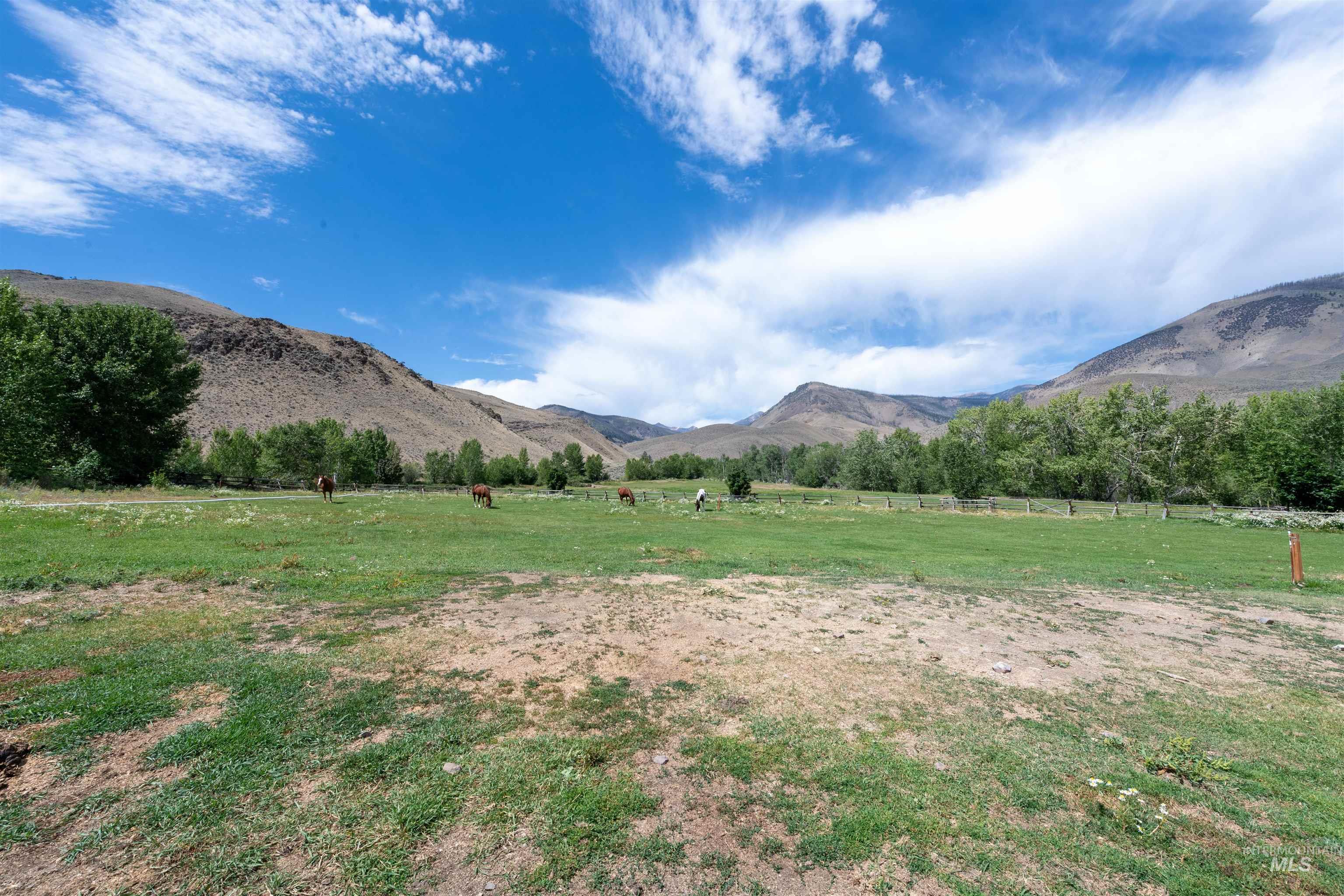 View of mountain backdrop with rural landscape