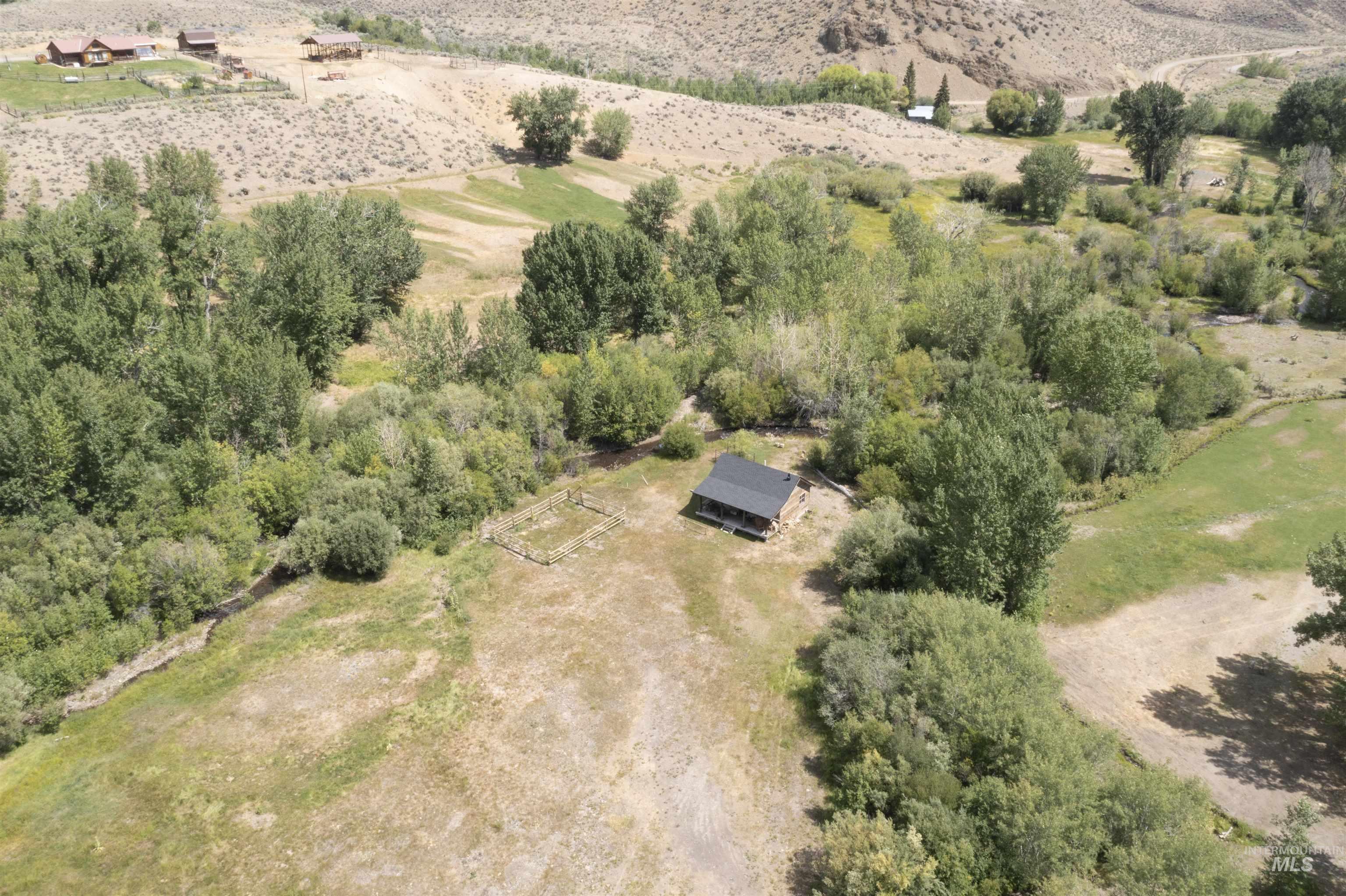 Aerial view of property and surrounding area featuring rural landscape