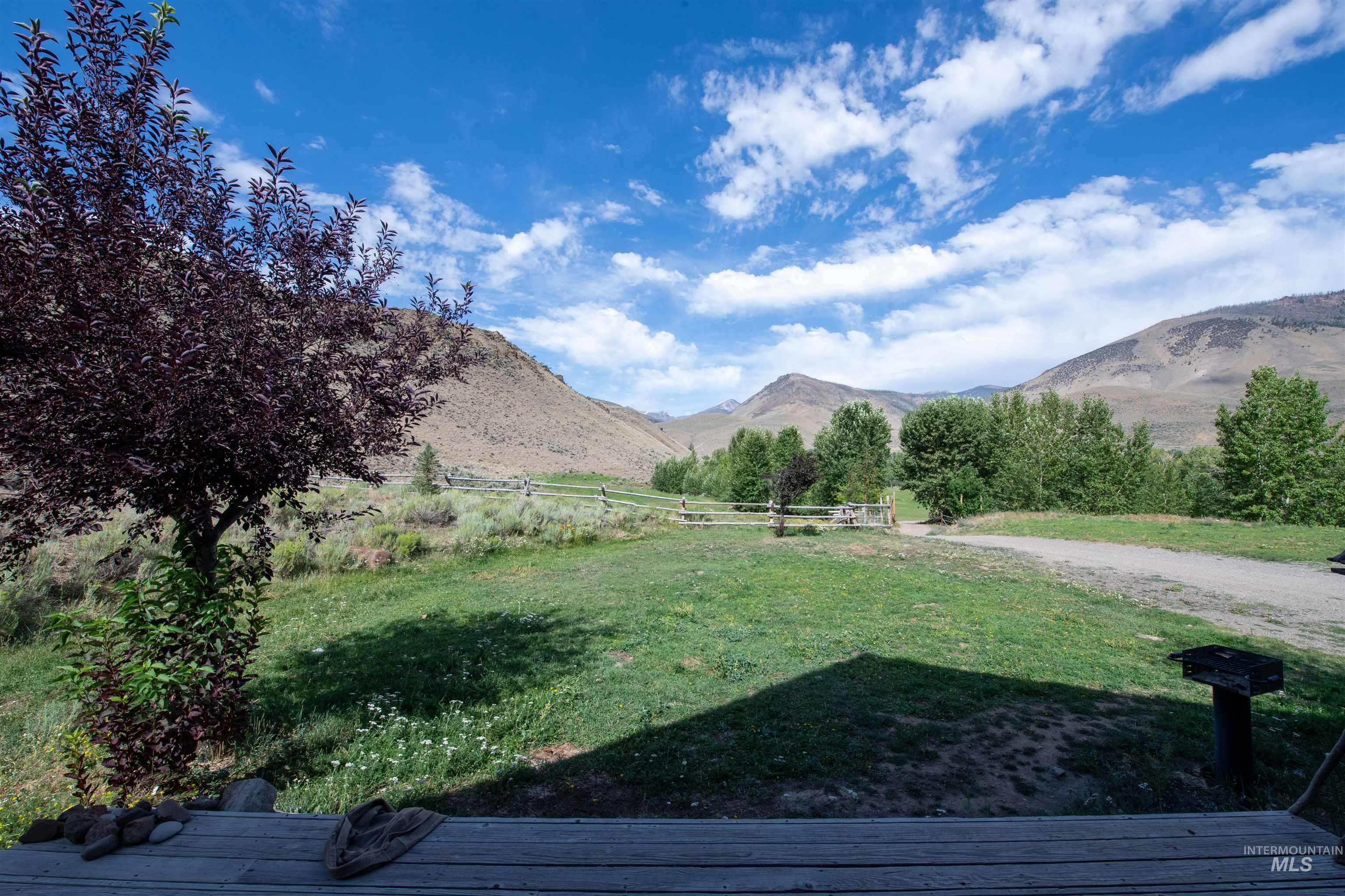 View of yard with a mountain view and a view of rural / pastoral area