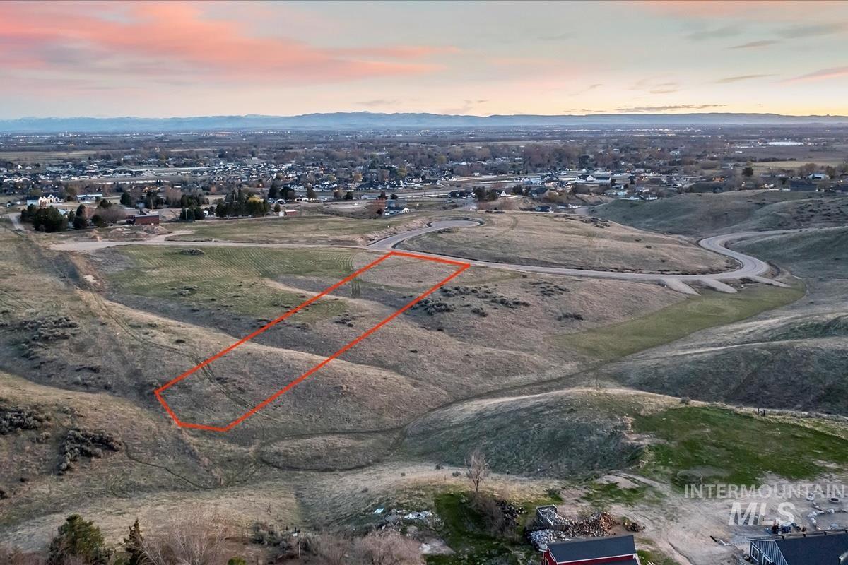 Aerial view at dusk of a mountain view and property boundaries highlighted