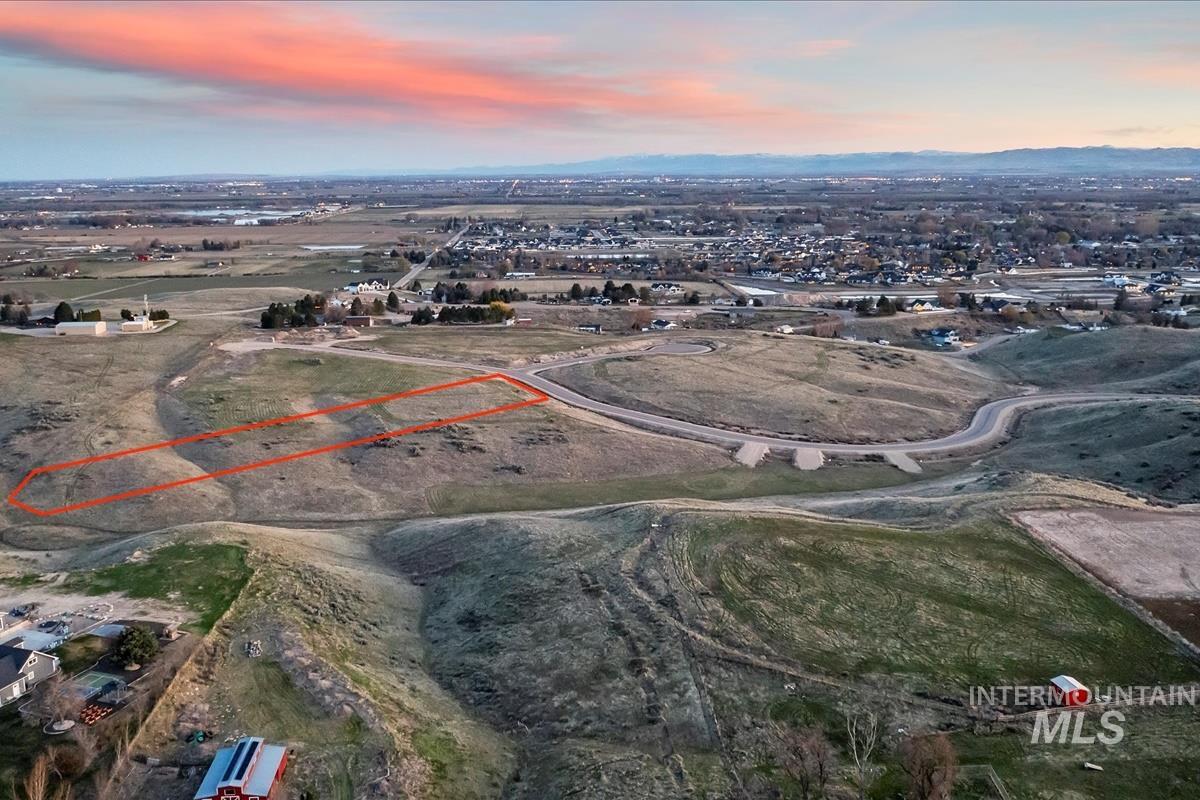 Aerial view at dusk of property parcel outlined and a view of rural / pastoral area
