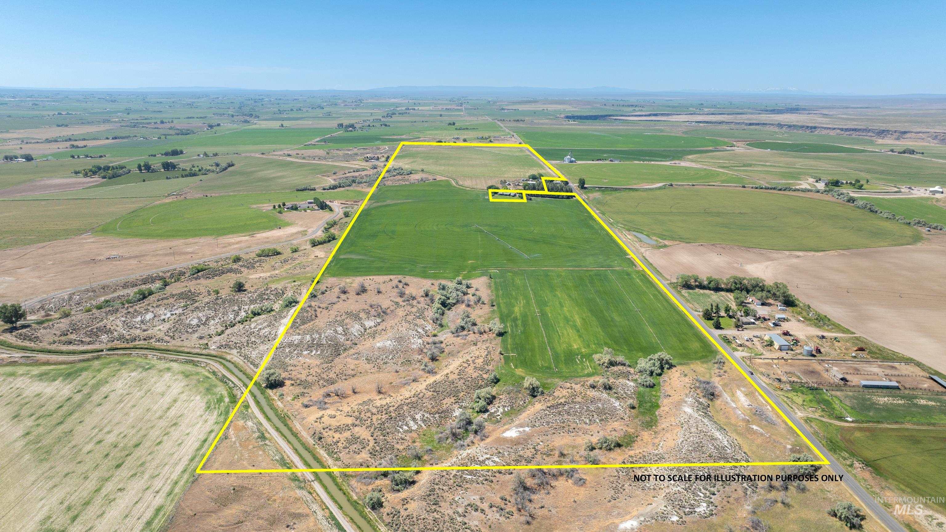 Overview of rural landscape with property boundaries highlighted and a mountainous background