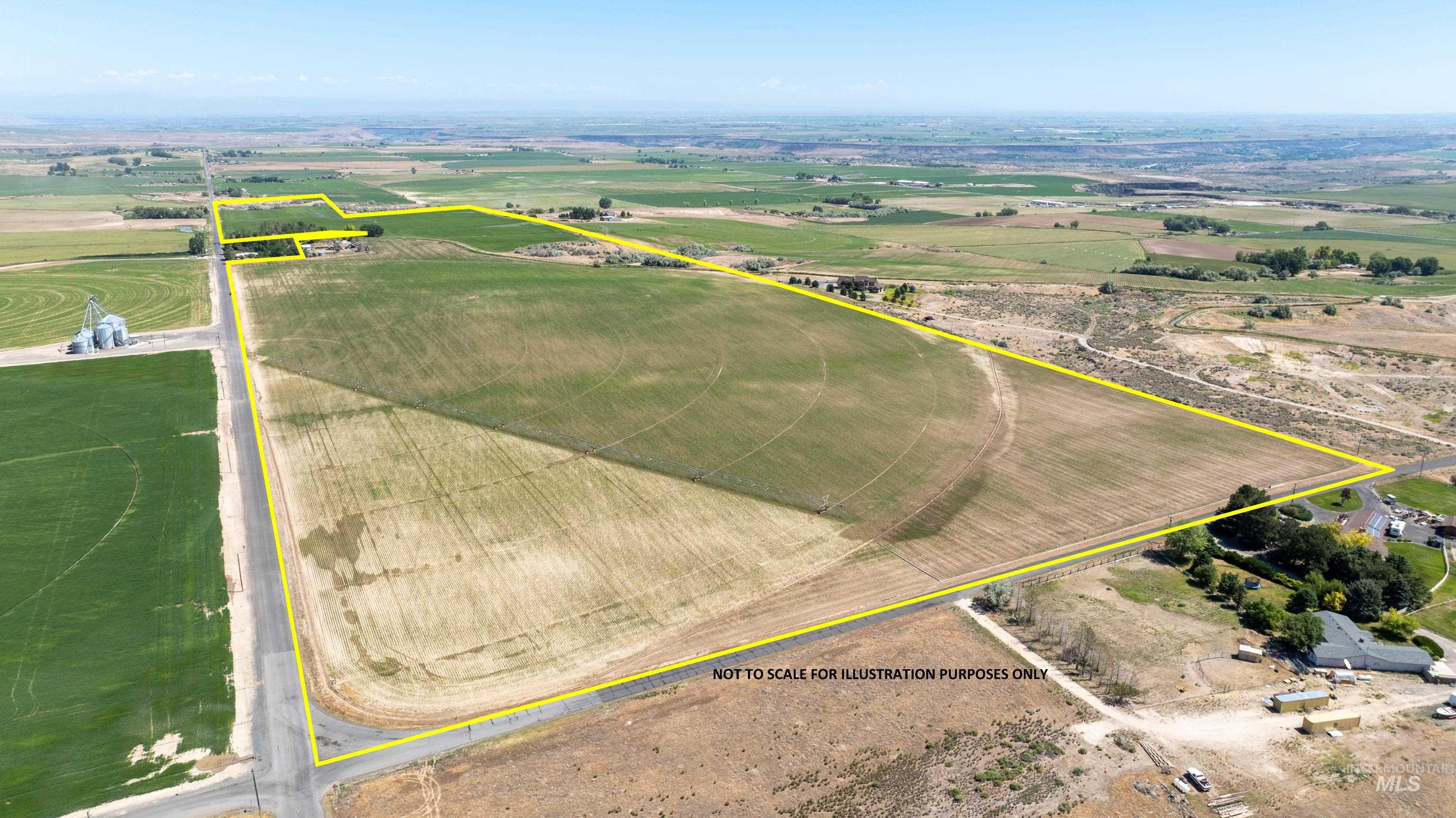 Overview of rural landscape featuring property parcel outlined and farmland
