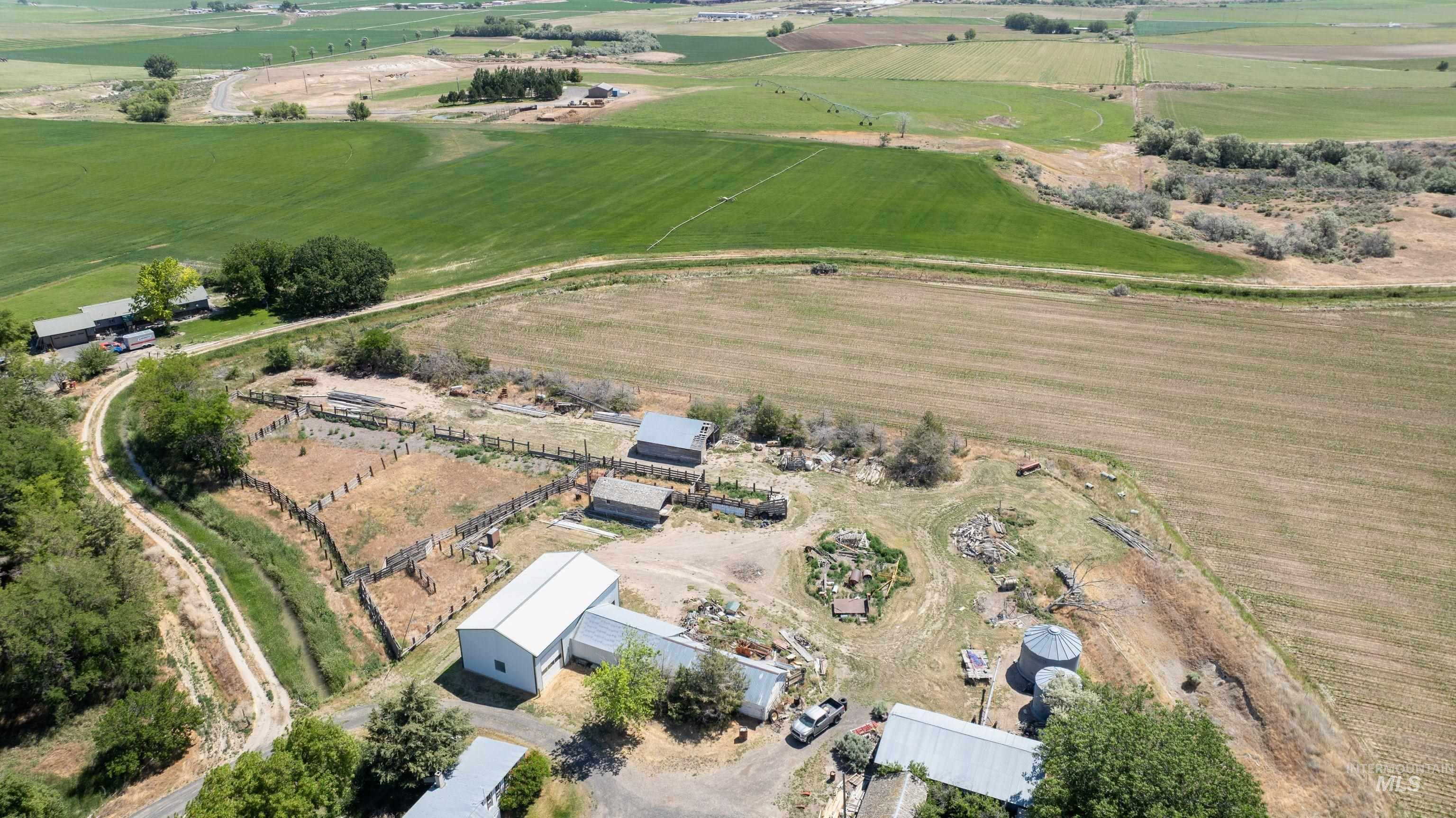 Aerial view of property's location featuring rural landscape and farmland