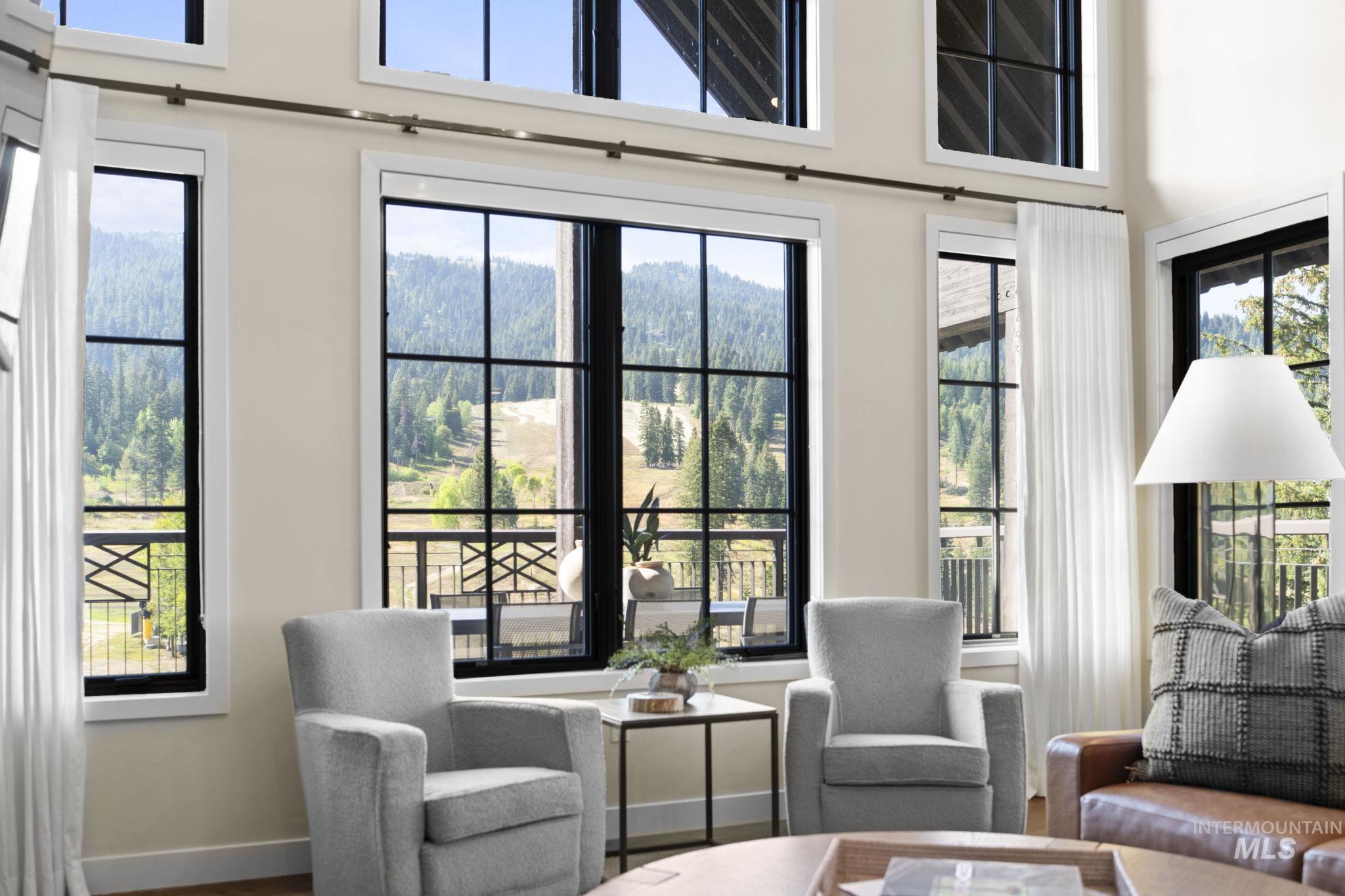 Sitting room featuring a forest view and wood finished floors