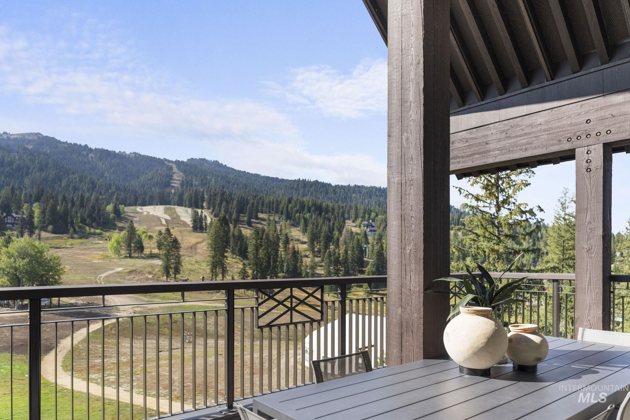 Deck featuring a forest view and outdoor dining space