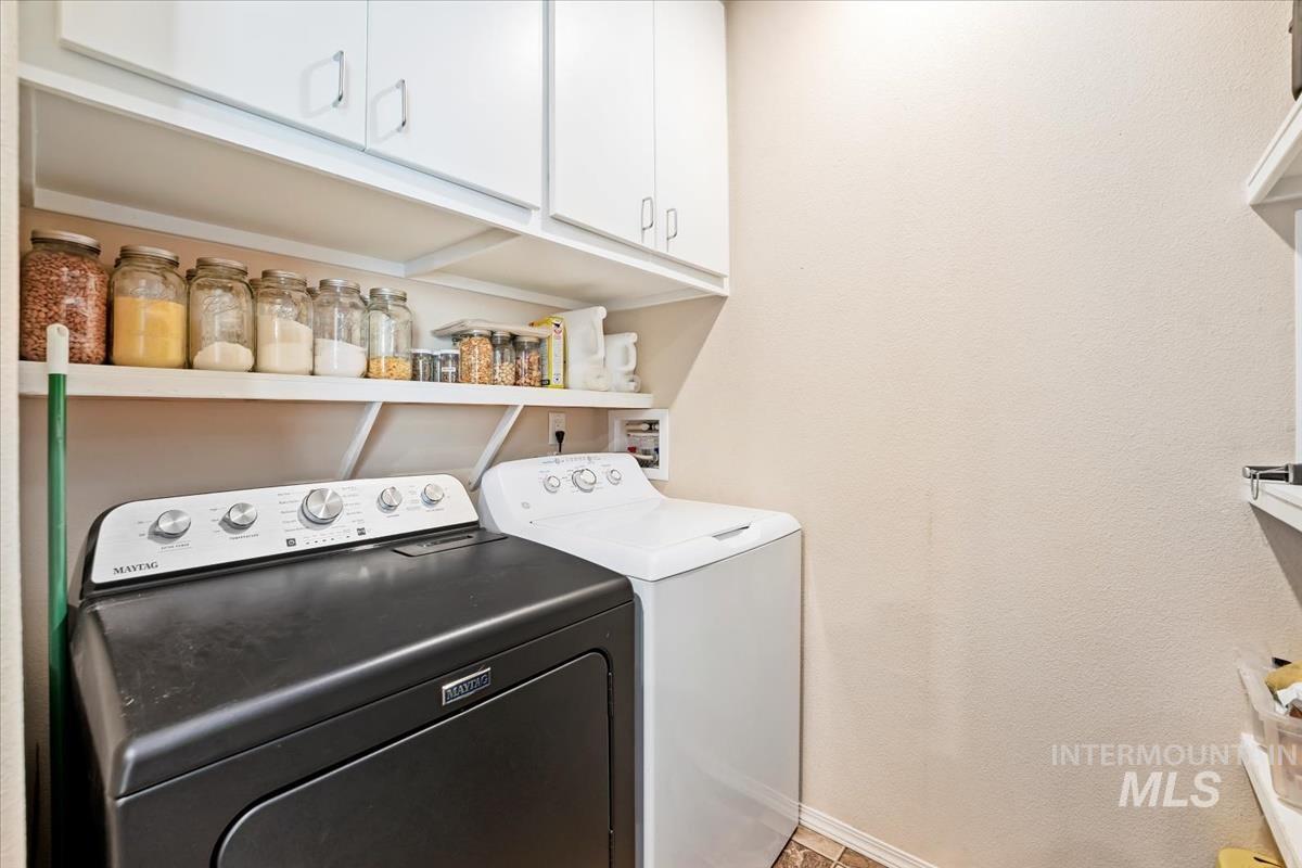 Washroom with separate washer and dryer and cabinet space