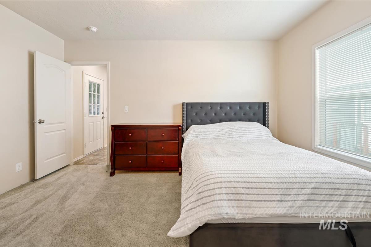 Bedroom with light carpet