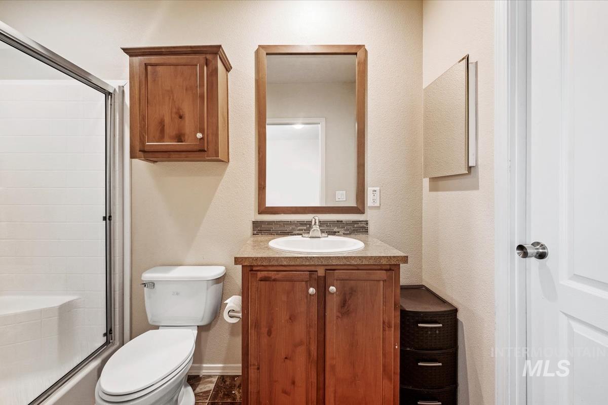 Bathroom with a shower stall and vanity