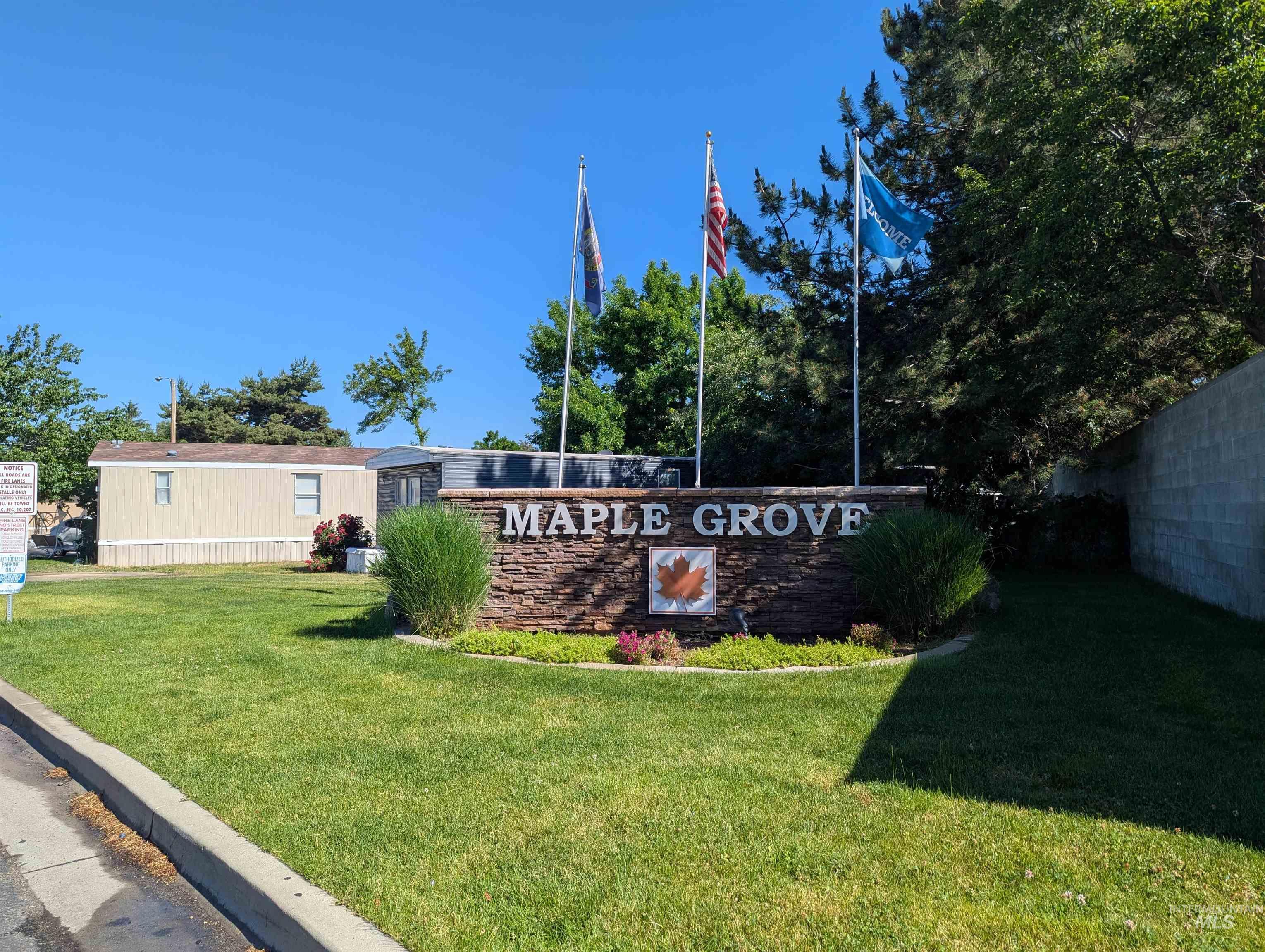 Community / neighborhood sign with a yard