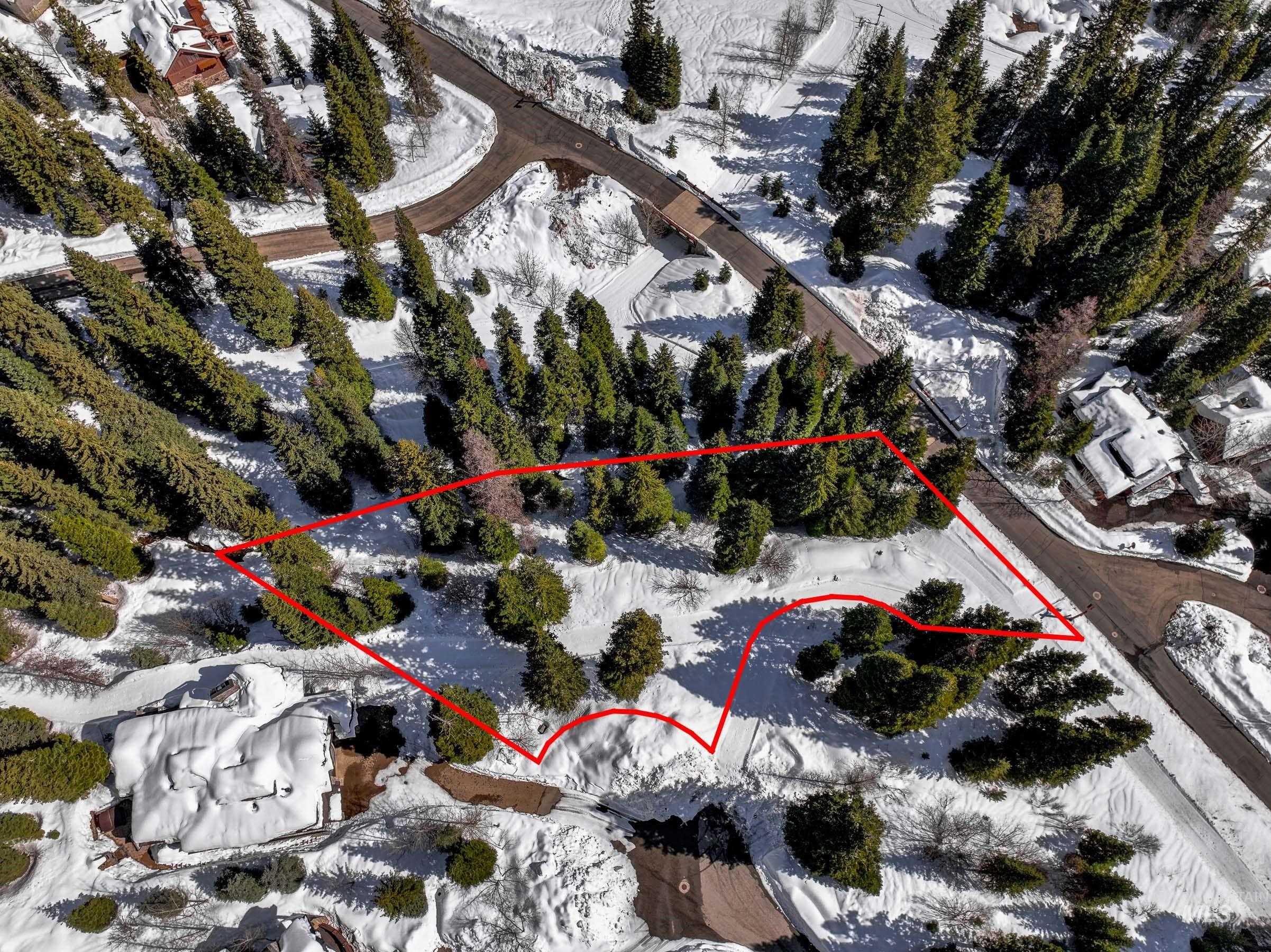 Snowy aerial view featuring property boundaries highlighted