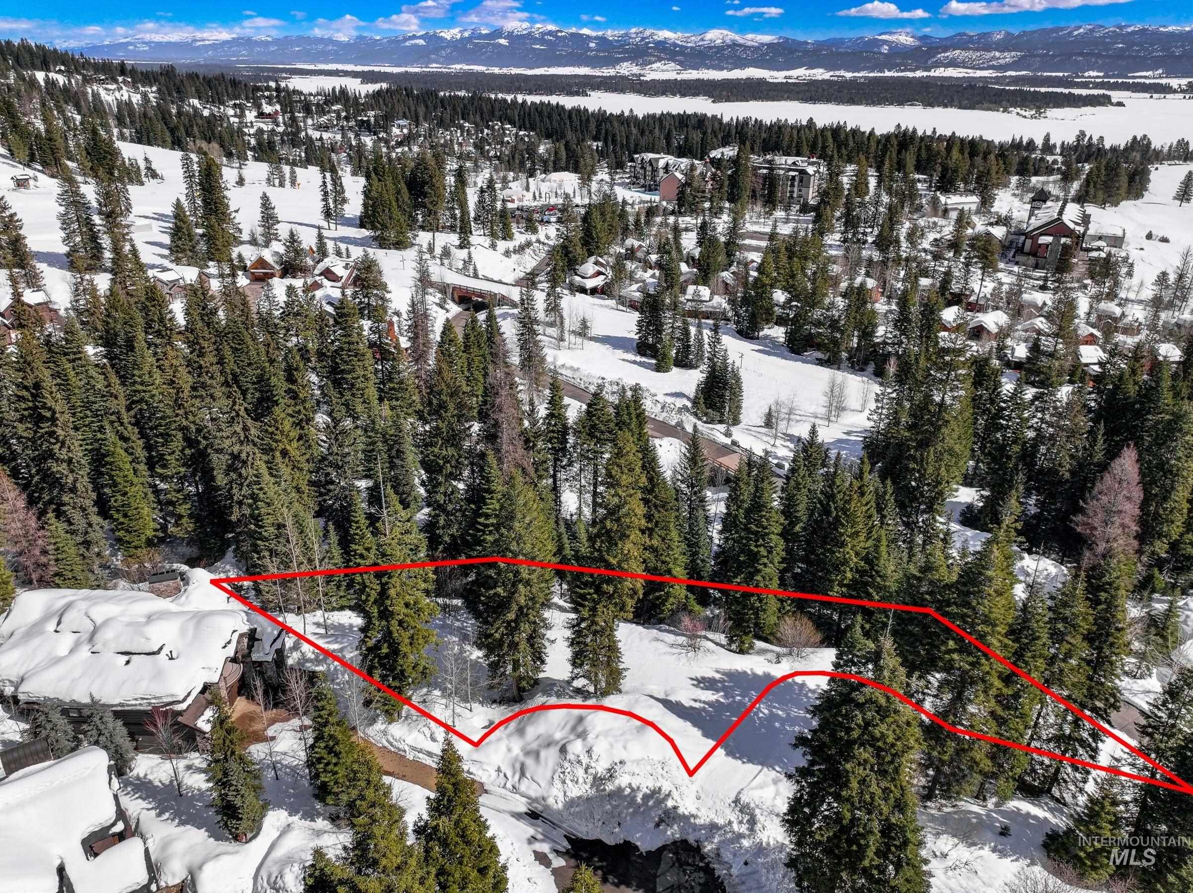 Snowy aerial view with property parcel outlined