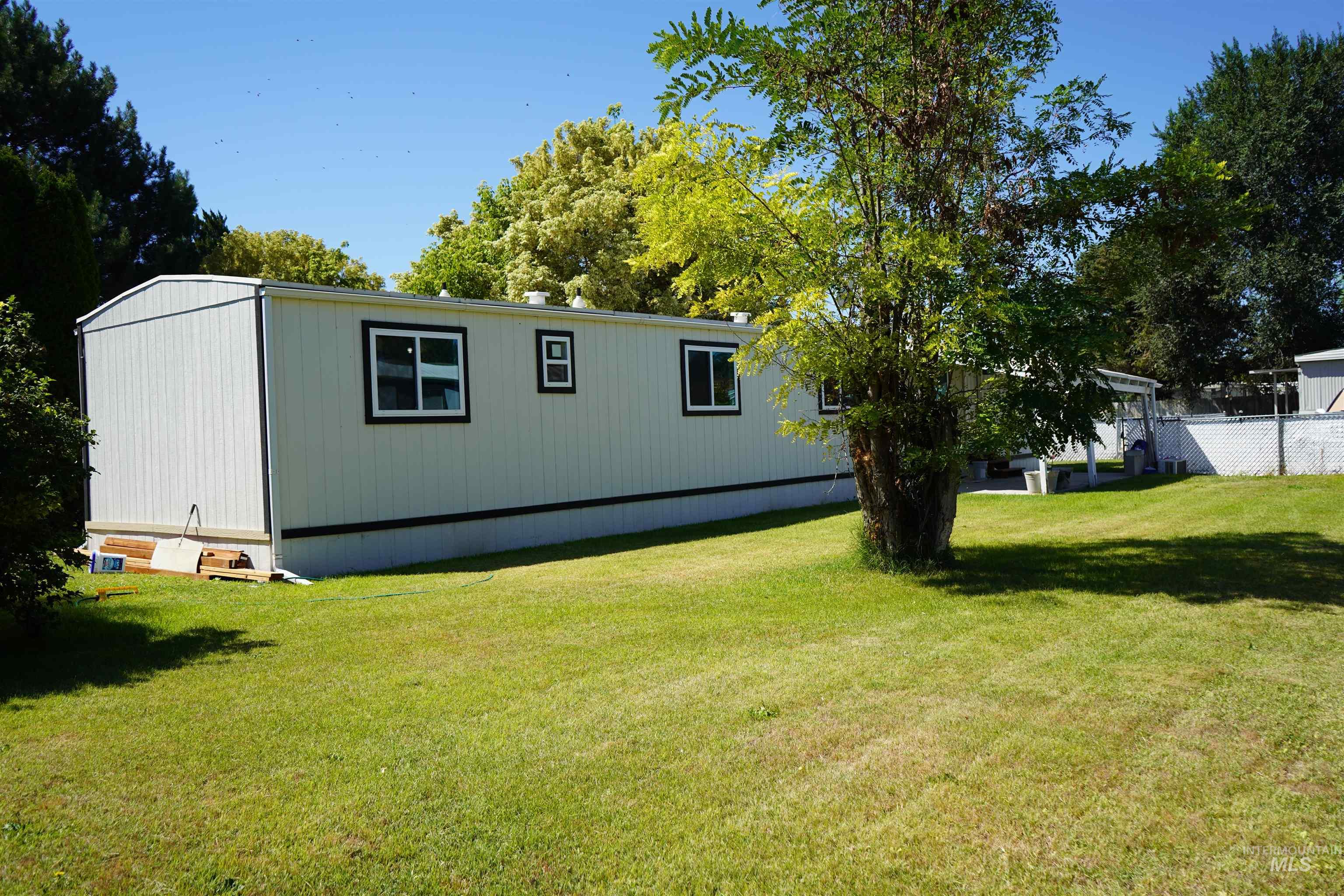 View of side of home with a lawn