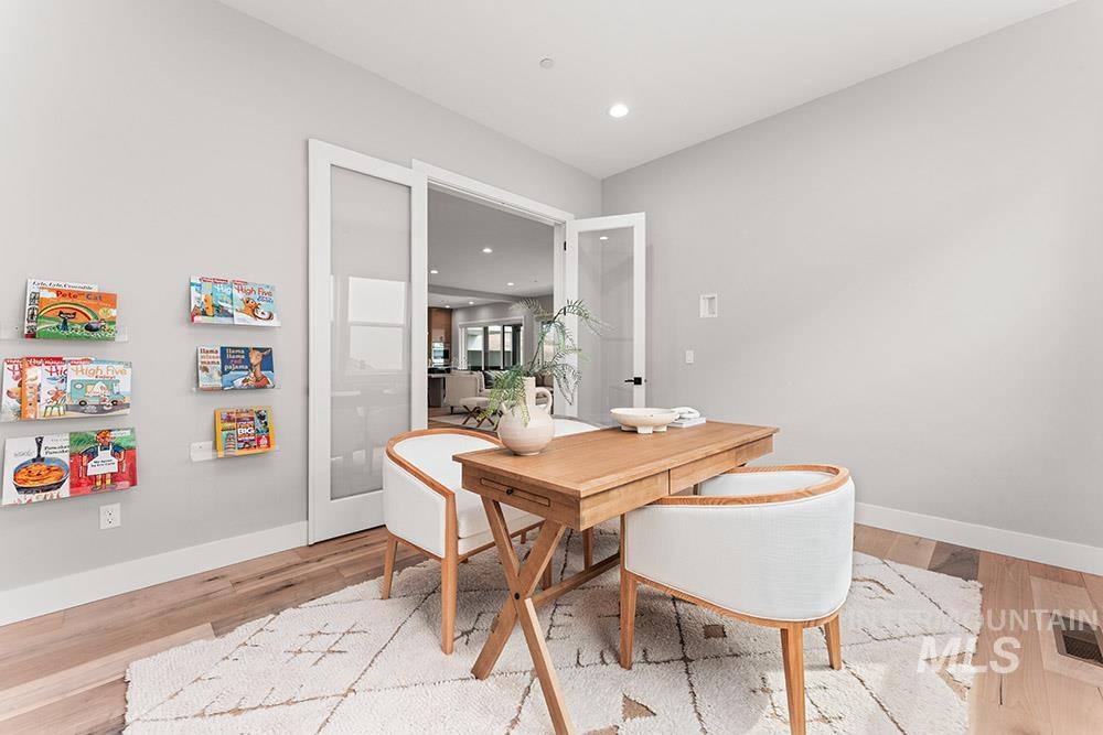 Dining space with recessed lighting and light wood-style flooring